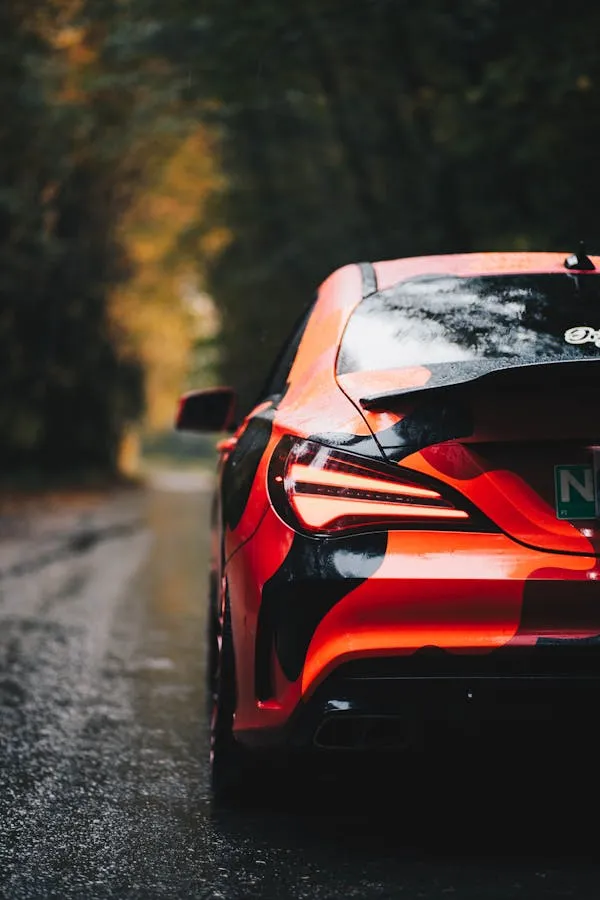 Red Mercedes Benz Driving Away Through Forest Trail