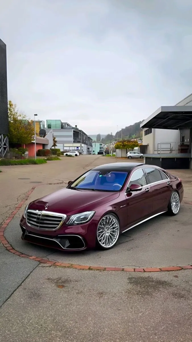 Red Mercedes Benz Parked in Urban Street during Day