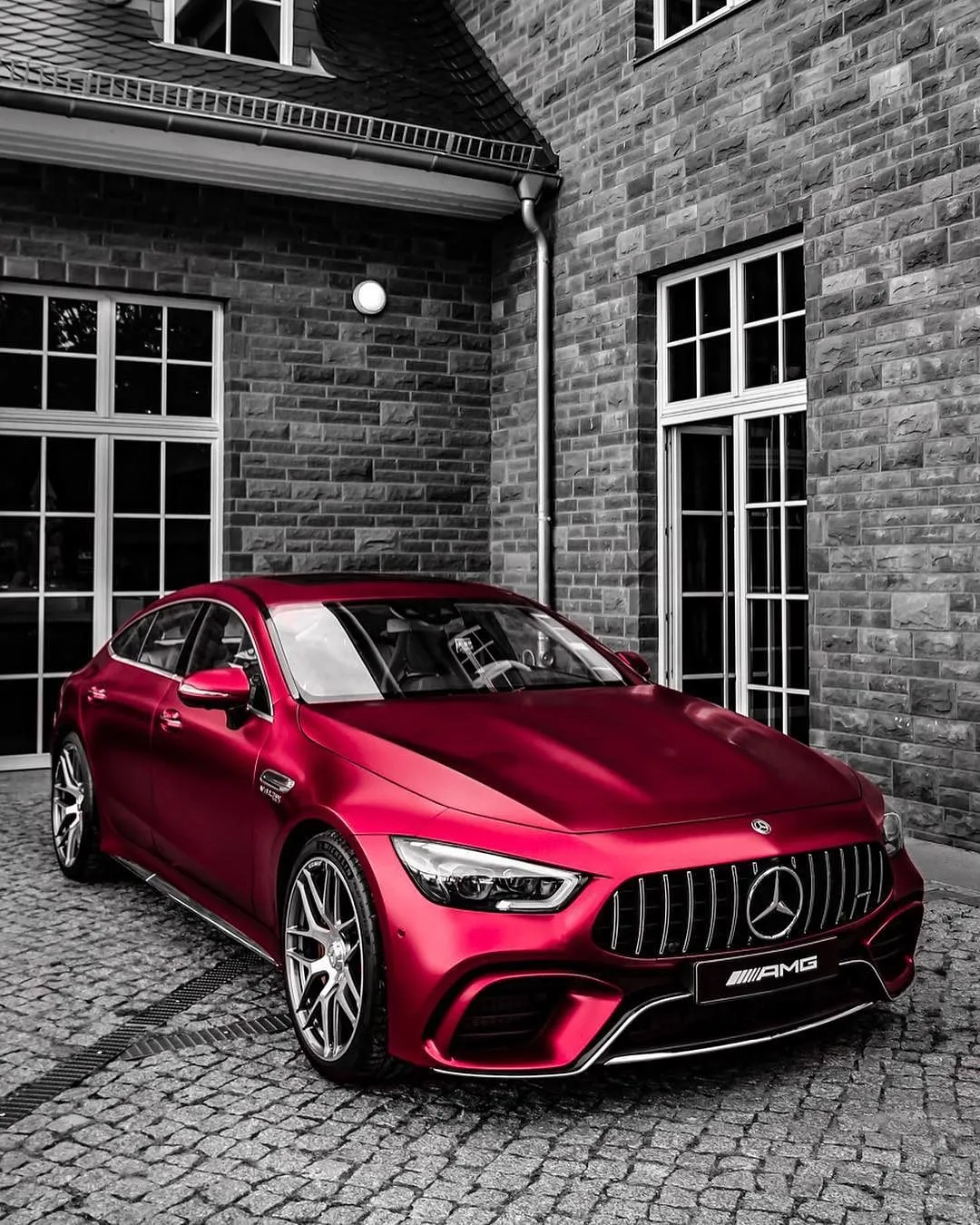 Red Mercedes Benz Sedan Parked Near Brick Building image
