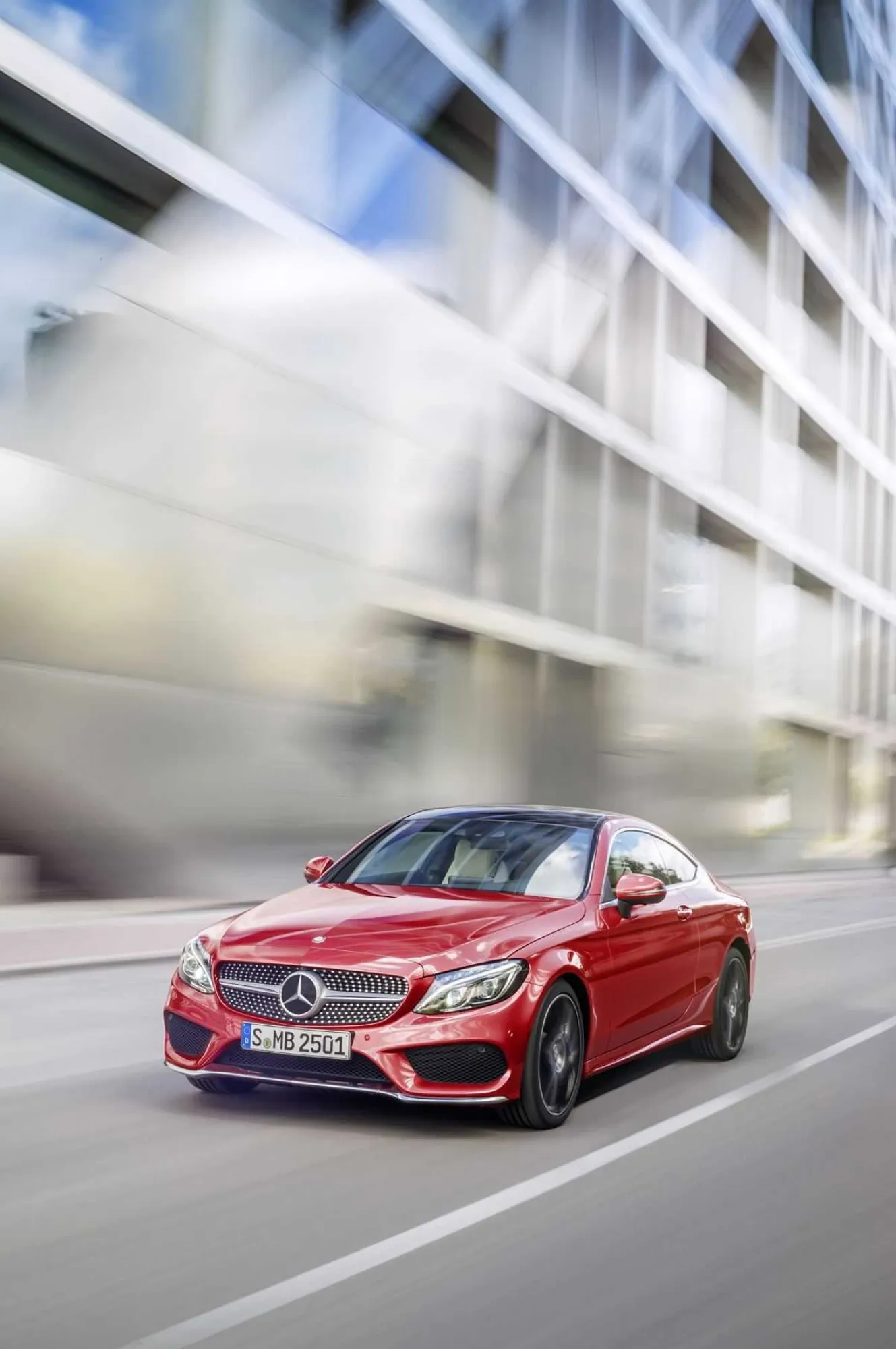 Red Mercedes Benz Sports Car Driving Fast in Urban Setting