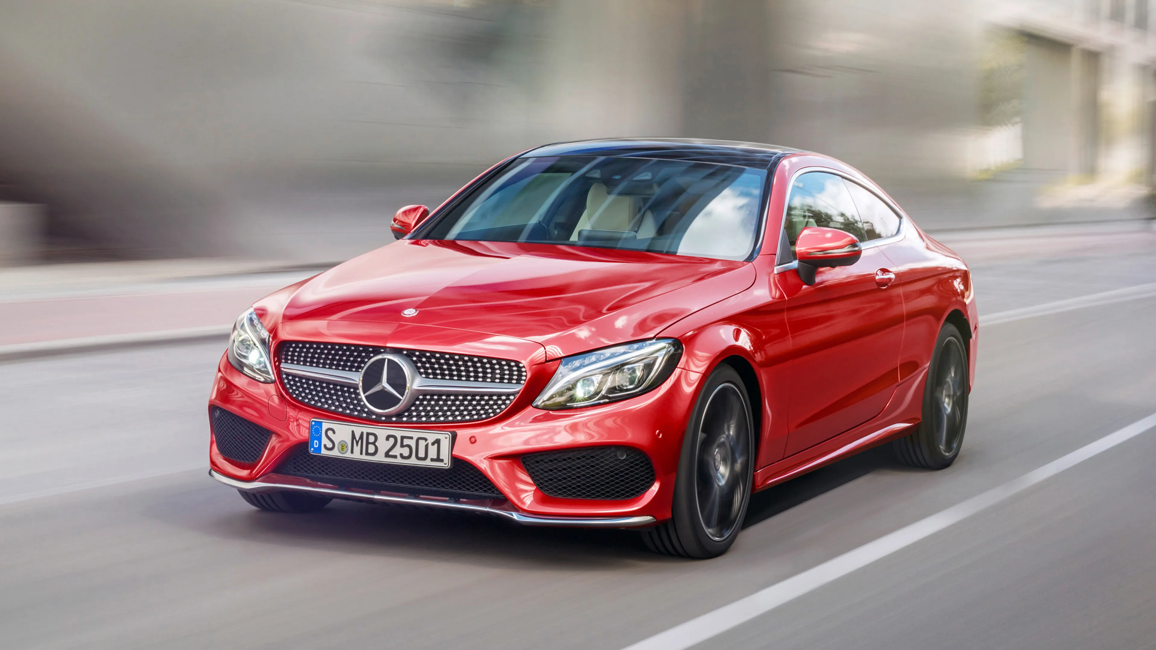 Red Mercedes Benz Sports Car Driving in Urban Area Wallpaper