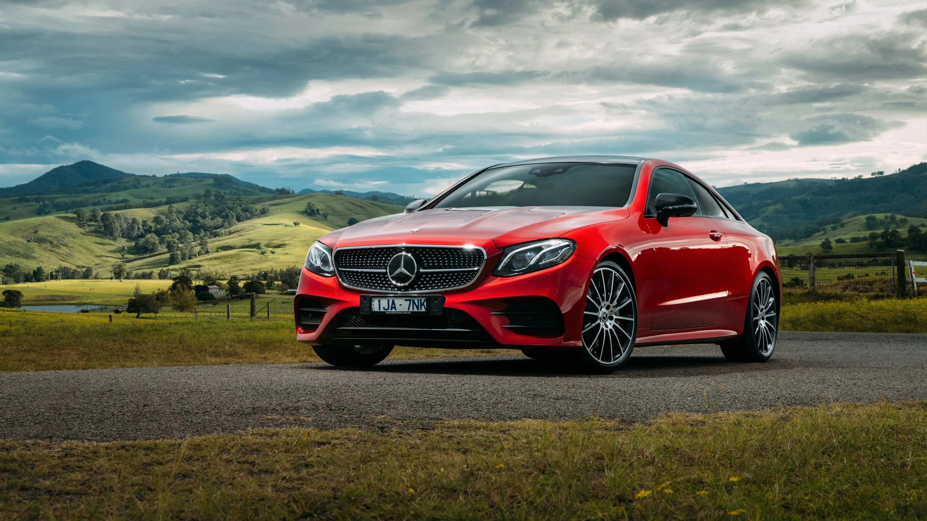 Red Mercedes Benz Sports Sedan Parked in Countryside image