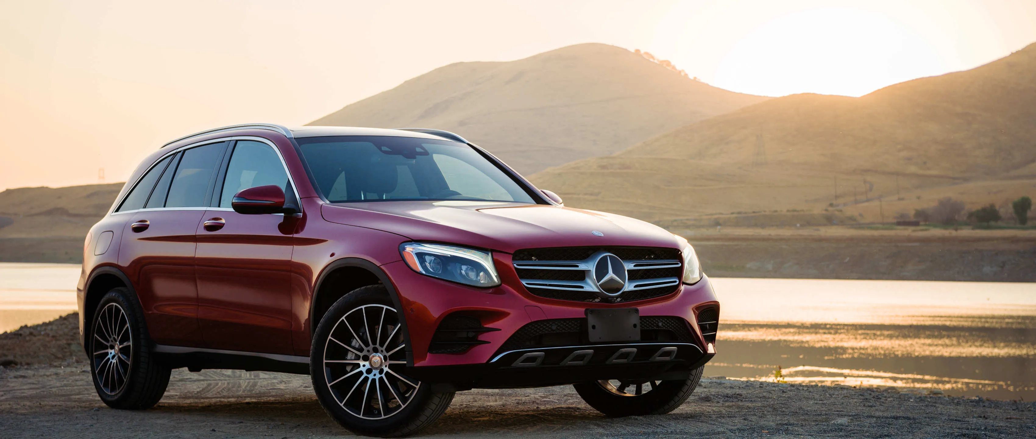 Red Mercedes Benz SUV by Mountain with Sunset Lighting