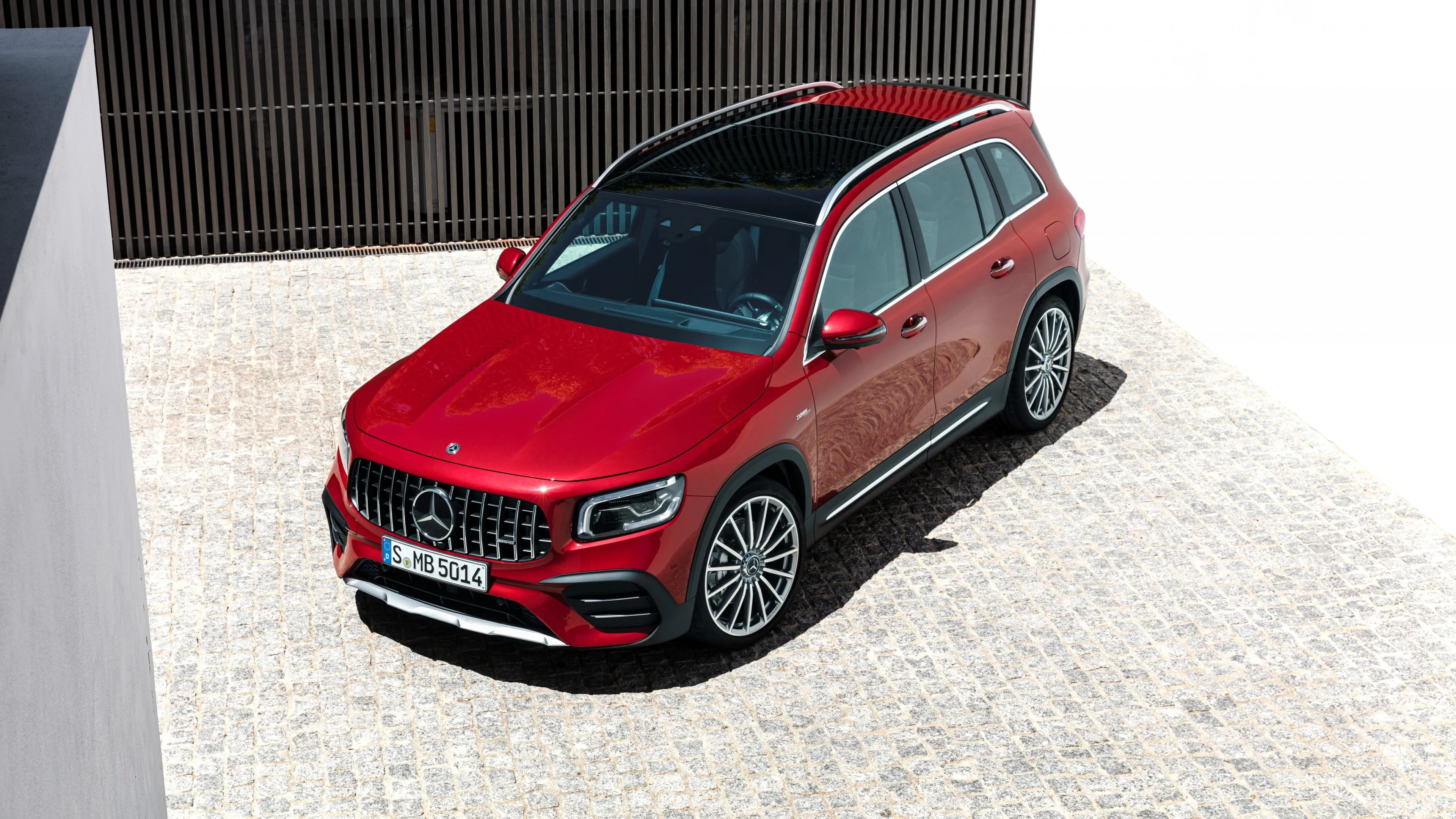 Red Mercedes Benz SUV Parked in Bright Courtyard Wallpaper