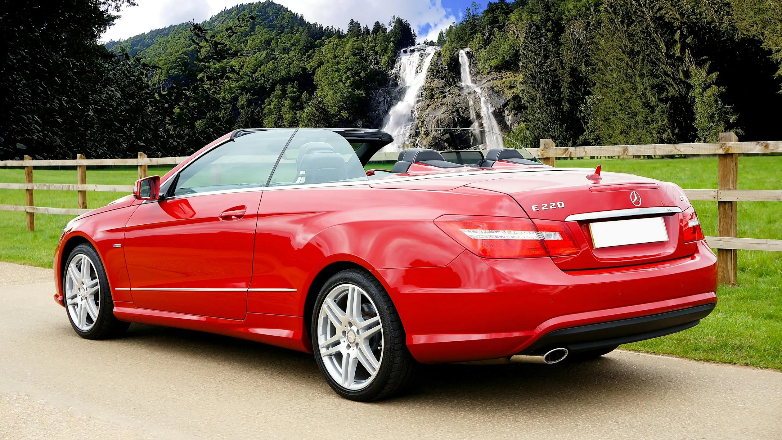 Red Mercedes Convertible Parked Near Fountains and Trees