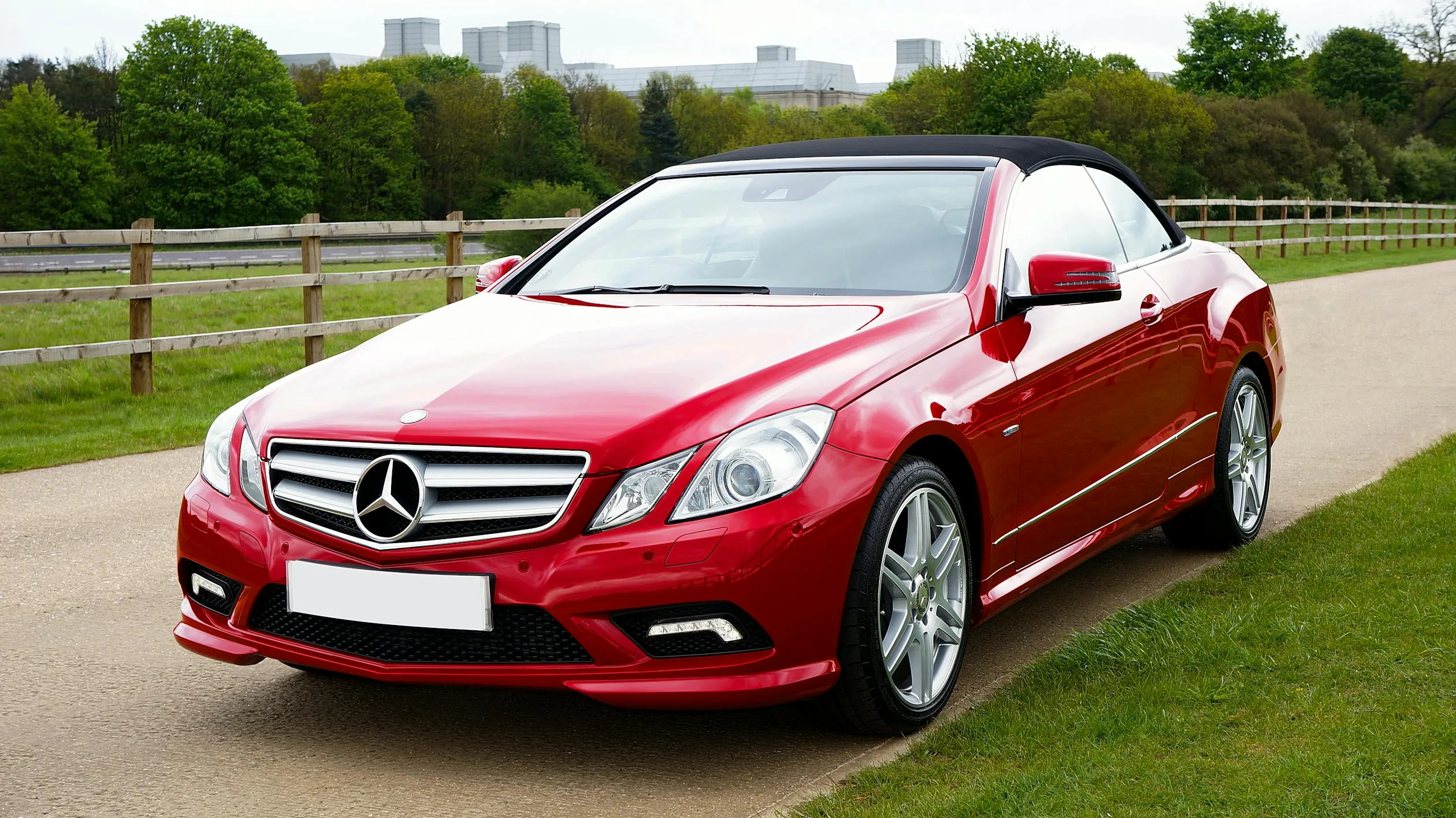 Red Mercedes Convertible Parked on Green Park Lawn
