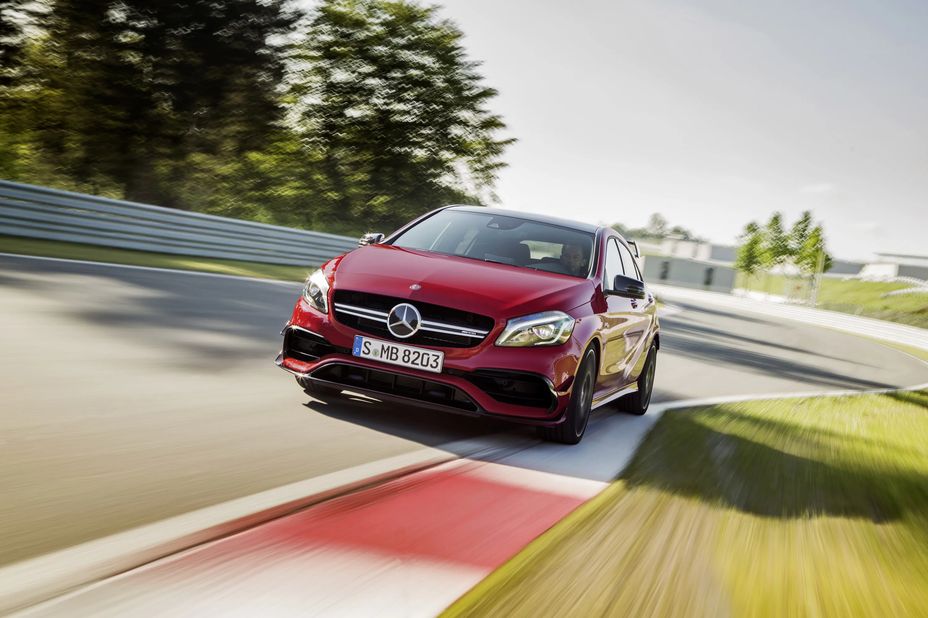 Red Mercedes Racing on High Performance Track HD image