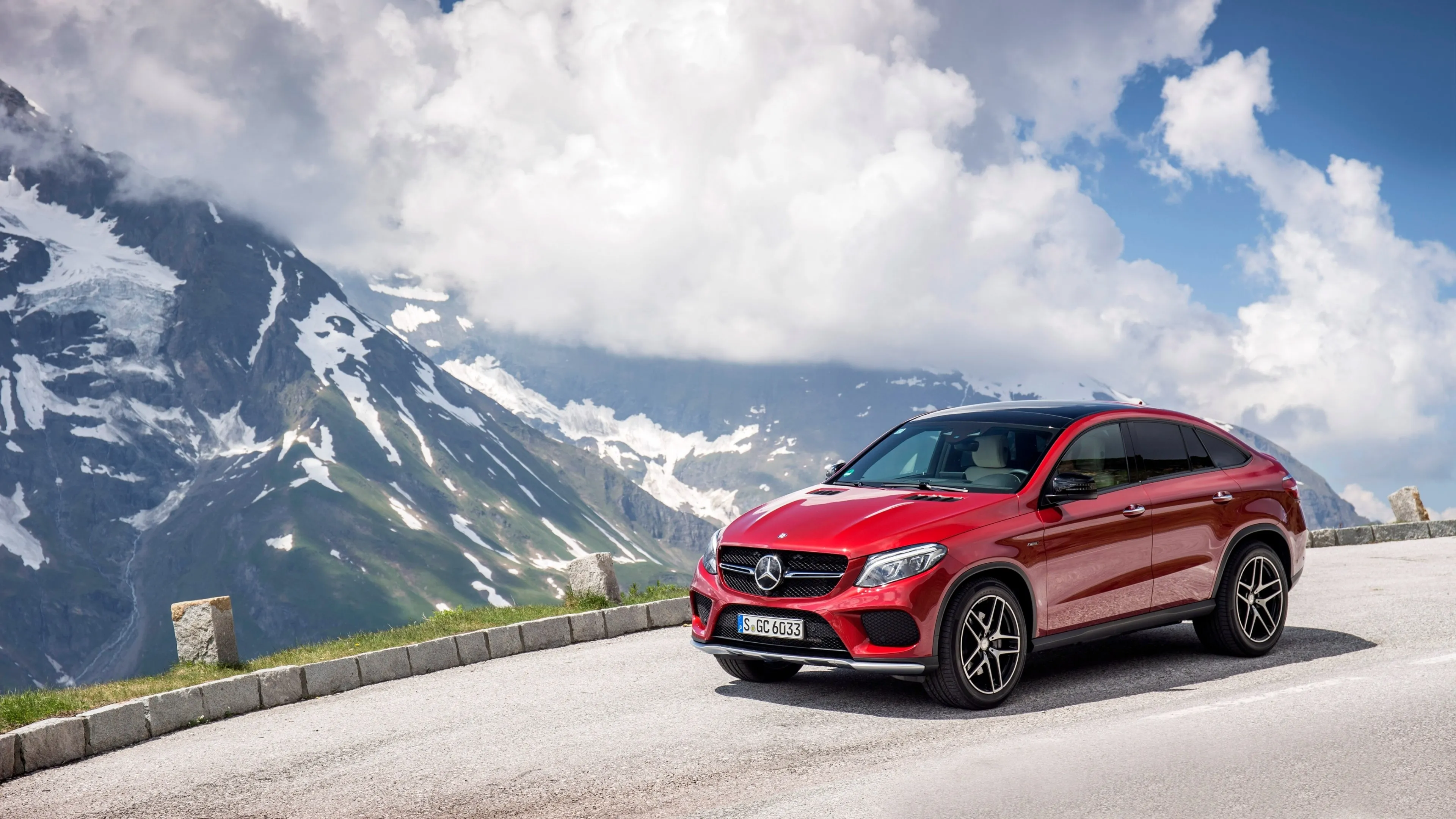 Red Mercedes SUV Driving Through Alpine Scenic Route