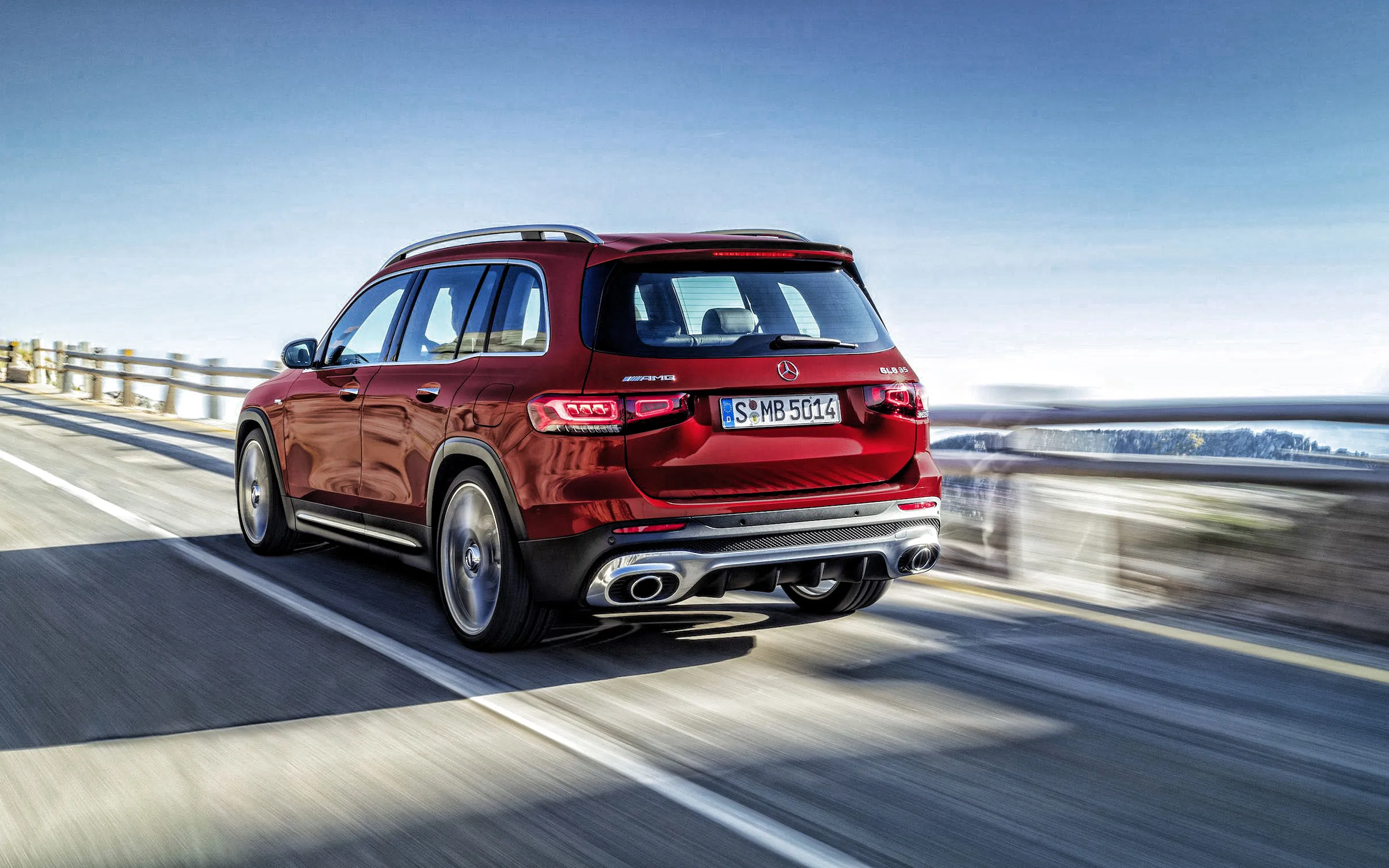 Red Mercedes SUV in Motion Along Scenic Coastal Highway