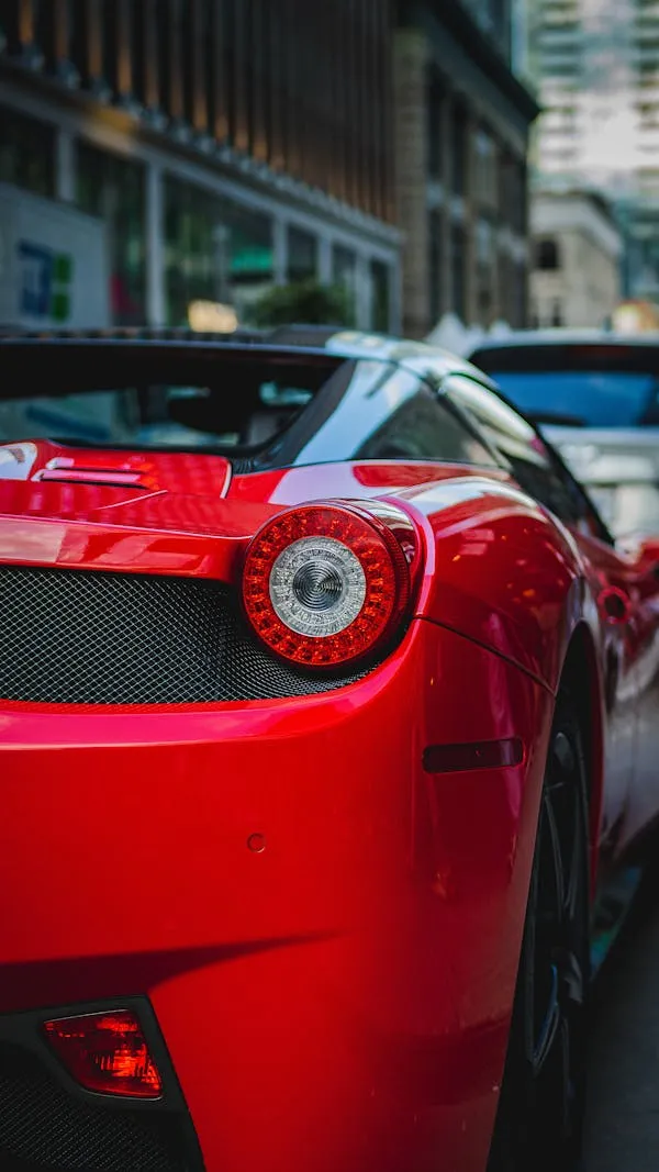 Red Sports Car Parked in Busy Urban Area Street Wallpaper