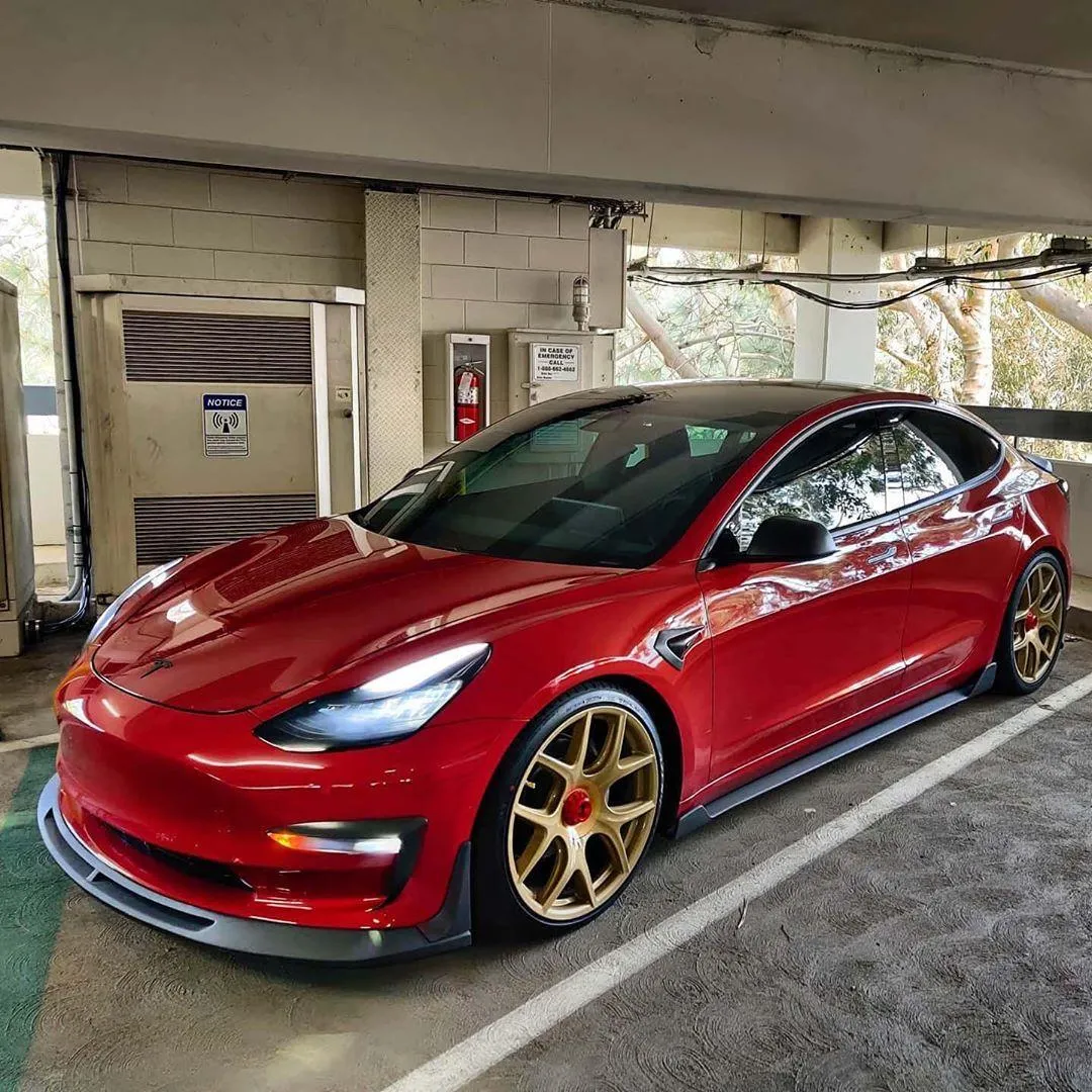 Red Tesla Model 3 Electric Car with Stylish Golden Rims