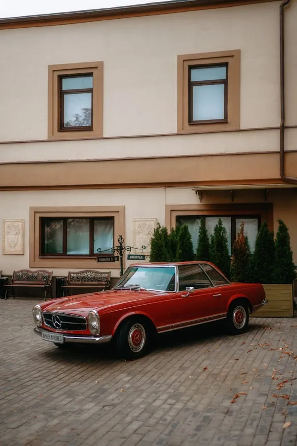 Red Vintage Mercedes Benz Car Parked by Residential Building