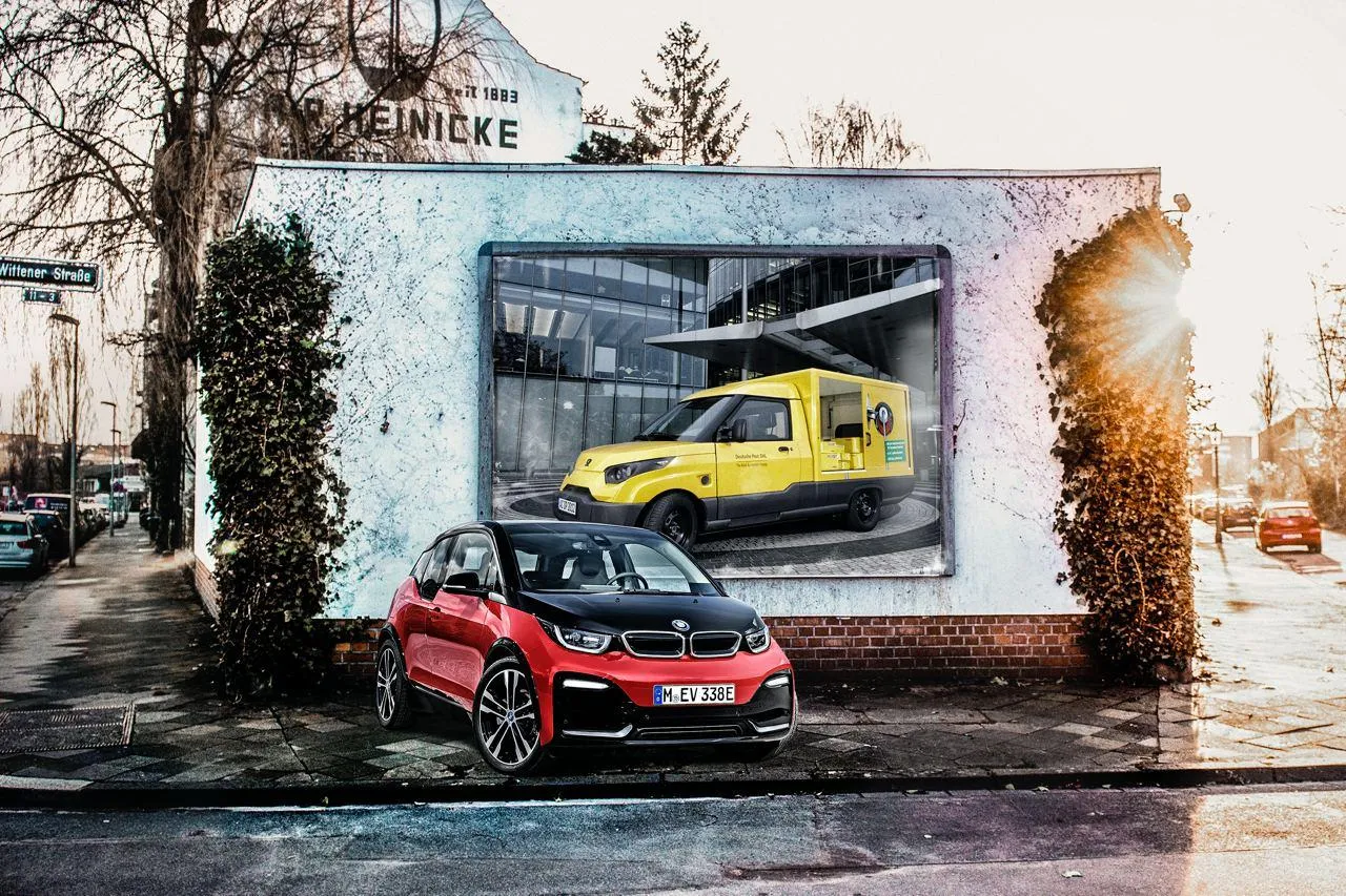 Red with Black Bmw Car Parked Near a Yellow Car Image