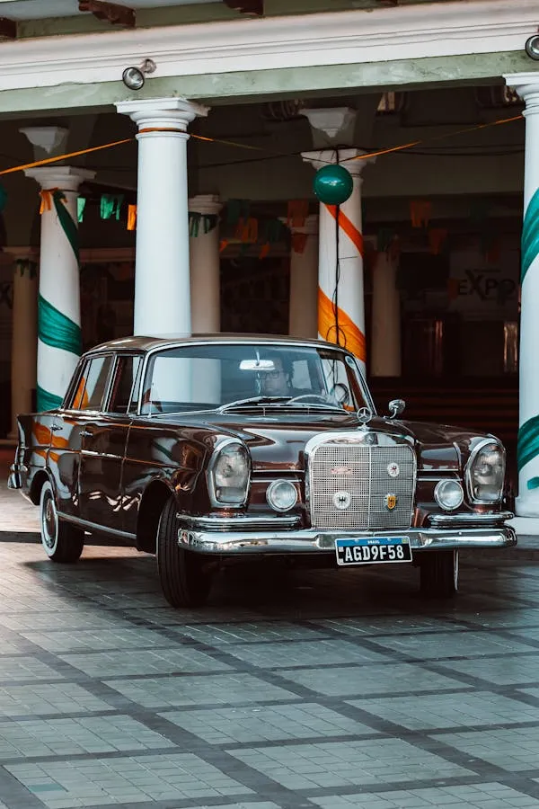 Restored Vintage Benz Outside Historical Building Wallpaper
