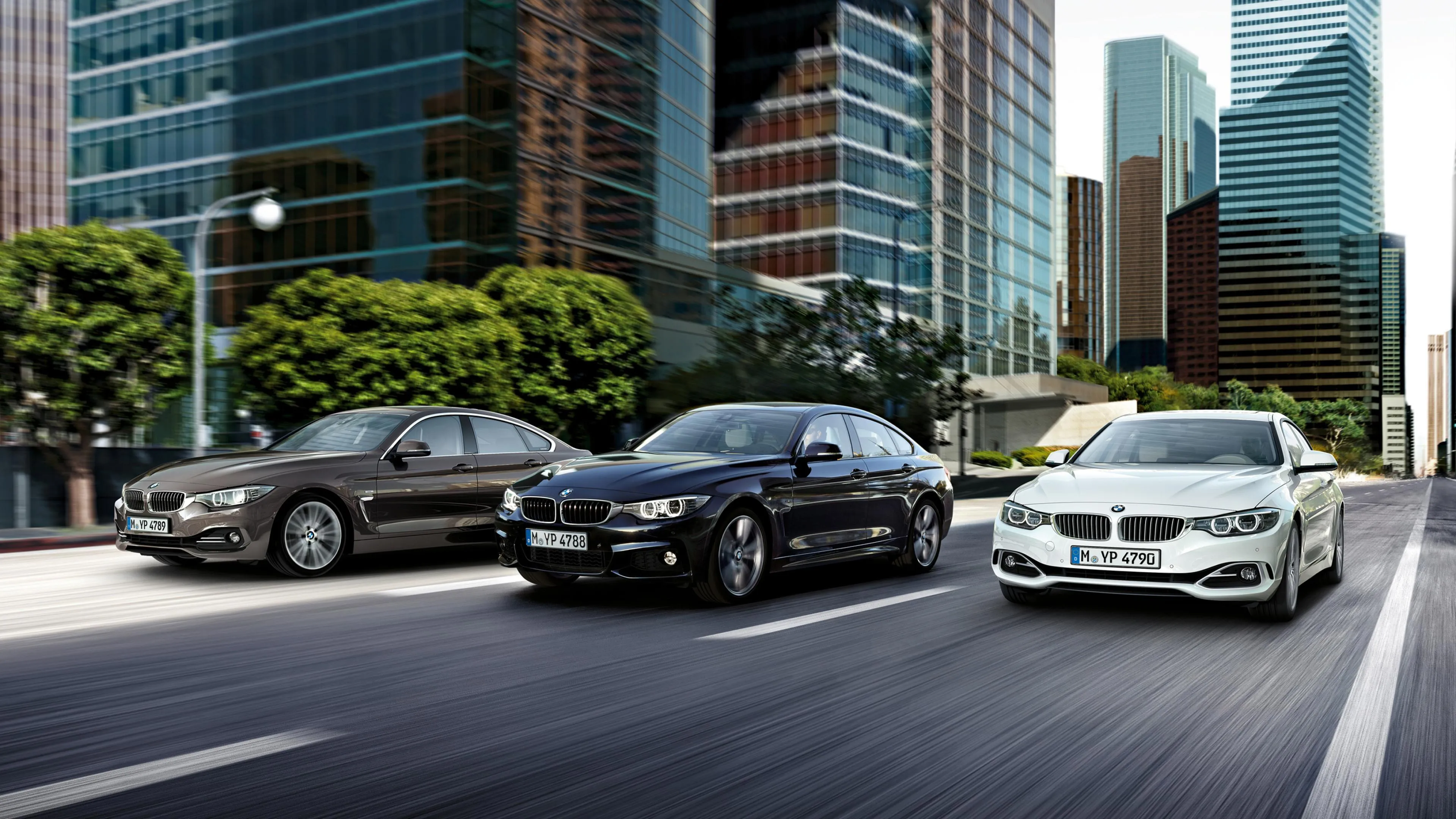 Row of Bmw Cars Parked in City with Modern Glass Buildings