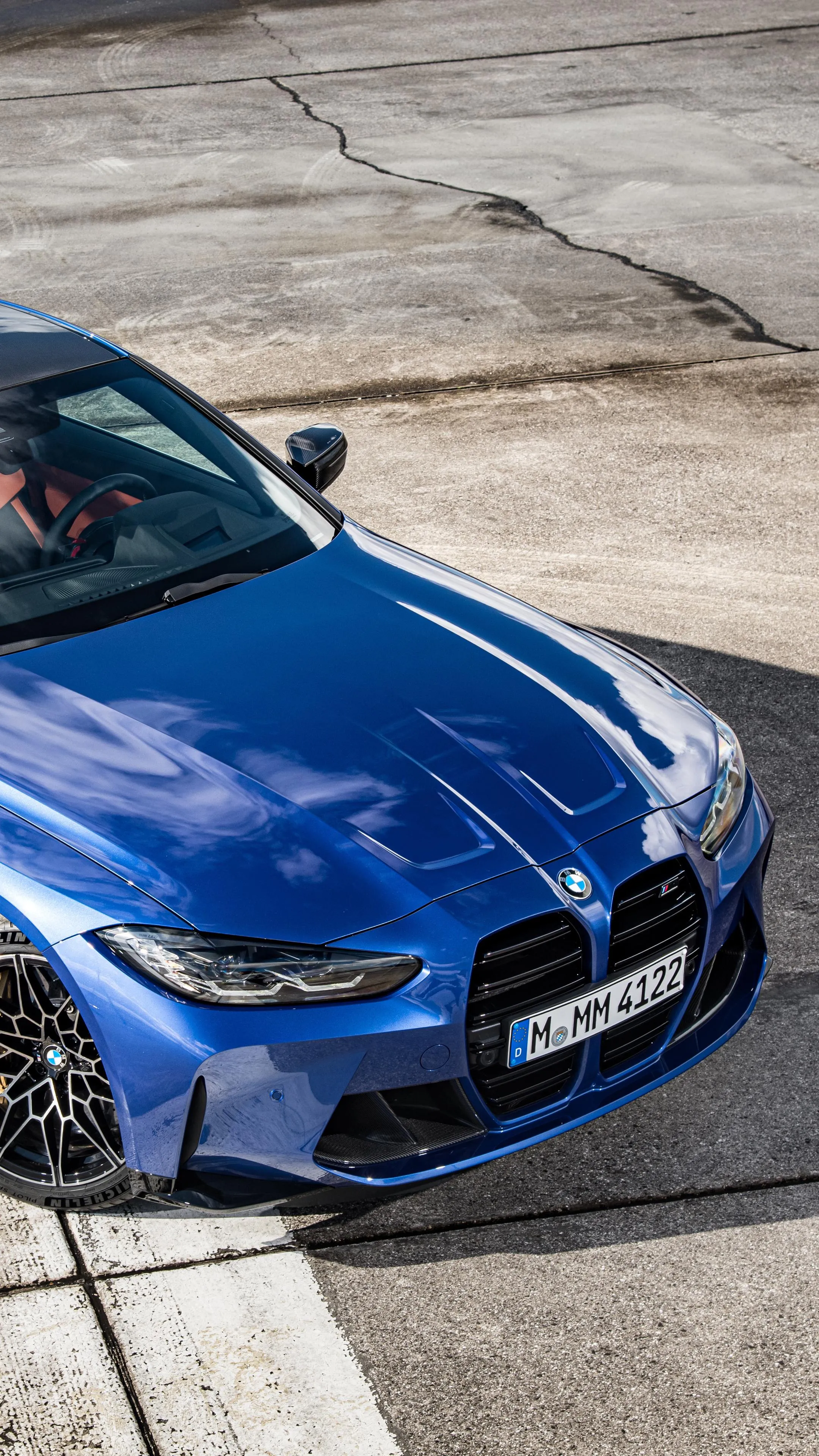Shiny Blue Bmw Parked on a Concrete Track Near Tire Barriers