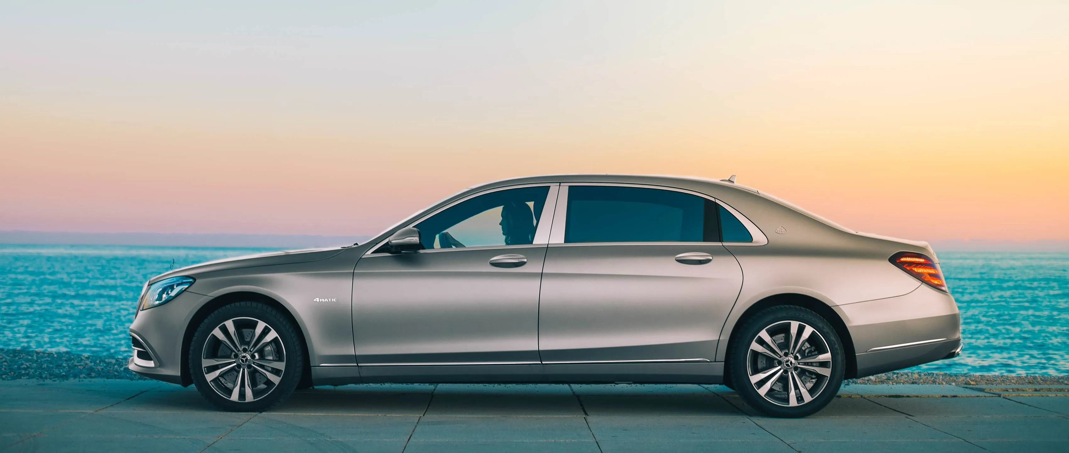 Side image of Silver Mercedes Sedan Parked in Ocean Shore