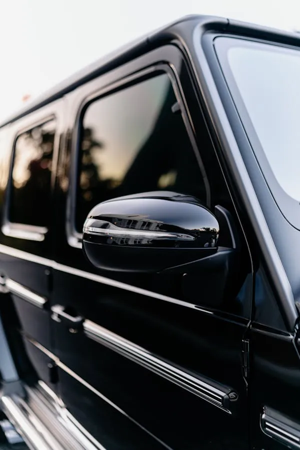 Side Mirror Reflection of Black Mercedes Benz G Class