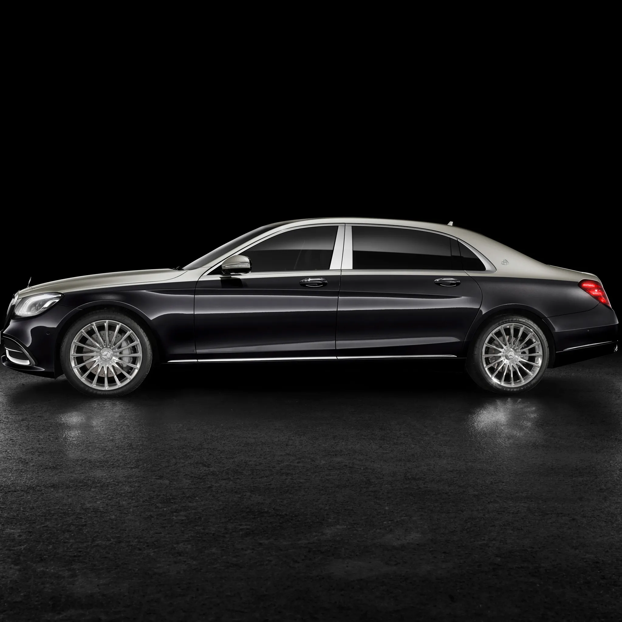 Side Profile of Black Mercedes Benz Sedan on Black Wallpaper
