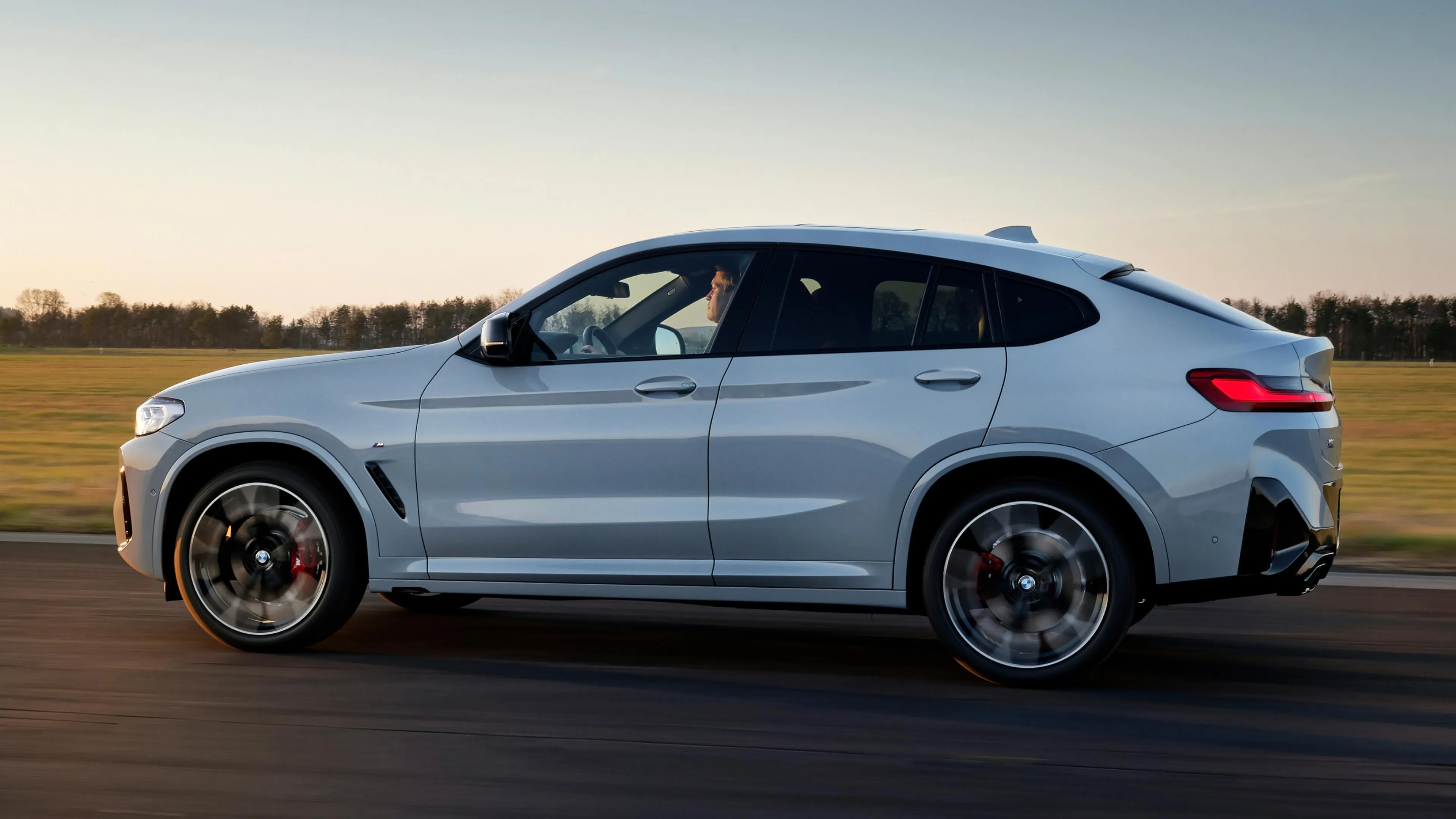 Side Profile of Bmw Sporty Suv Driving on Race Track