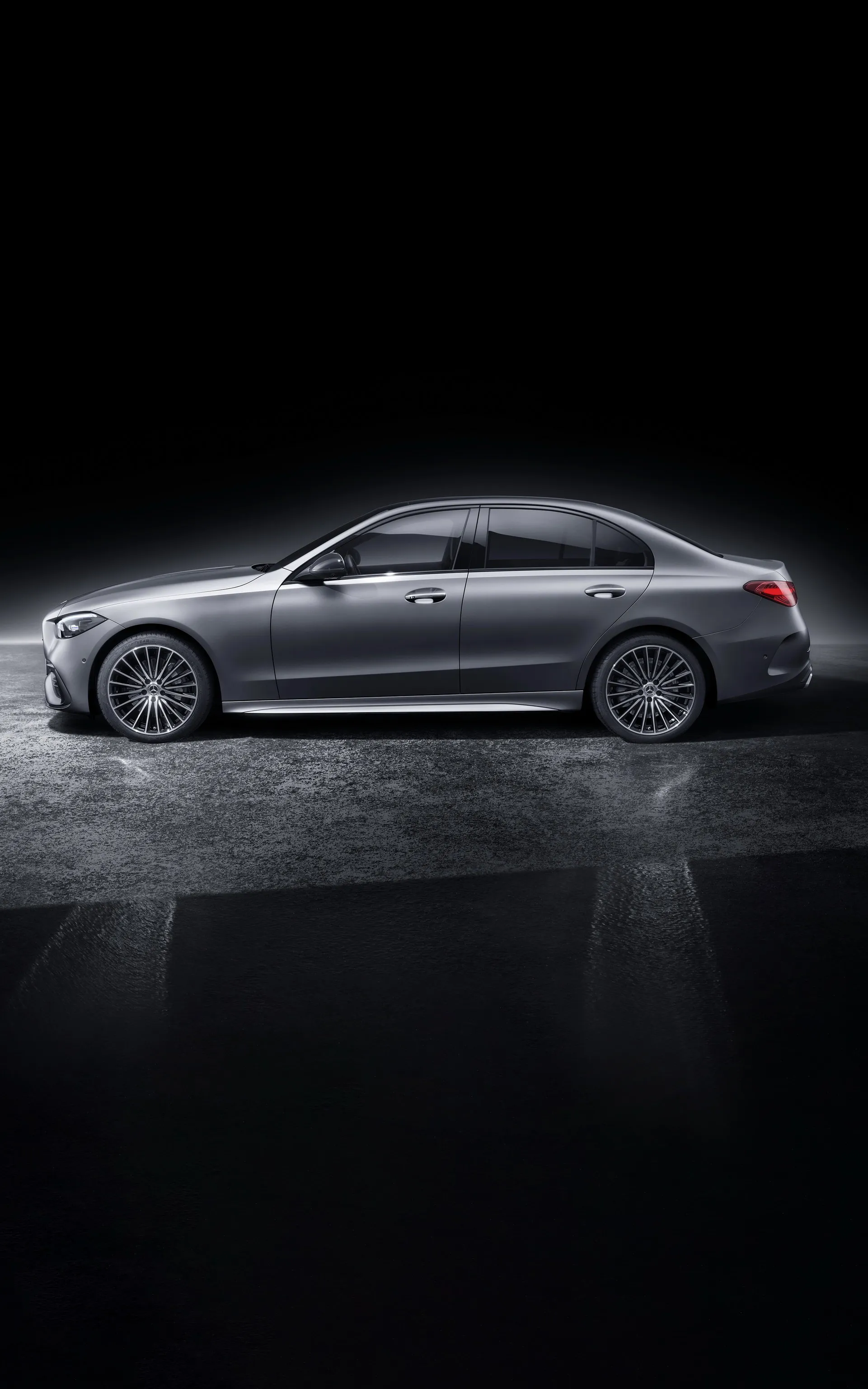 Side Profile of Grey Mercedes Benz Sedan on Dark Backdrop