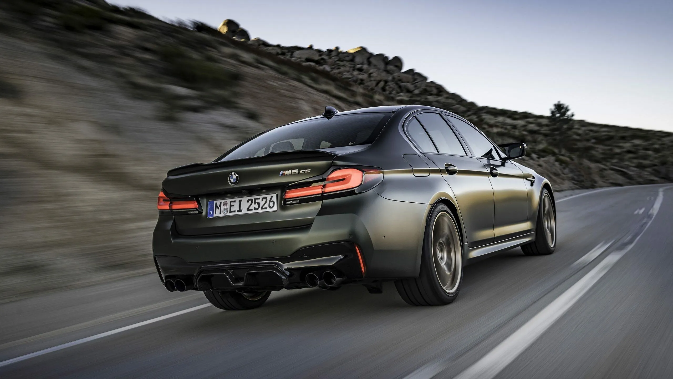 Side Rear View of Black Bmw Driving on Mountain Road