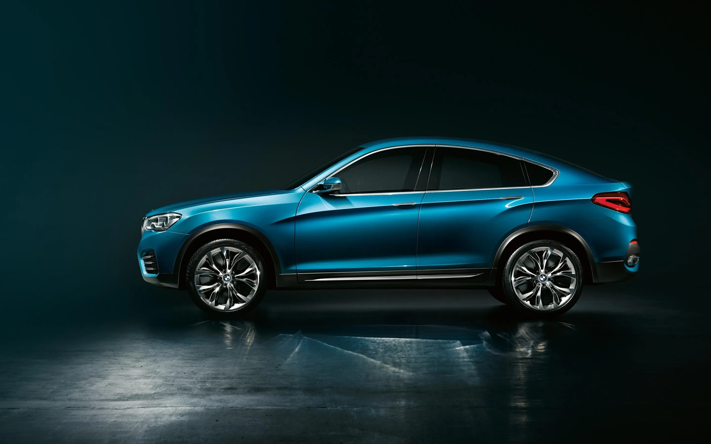 Side View of a Blue Bmw Car in a Dark Studio Setting