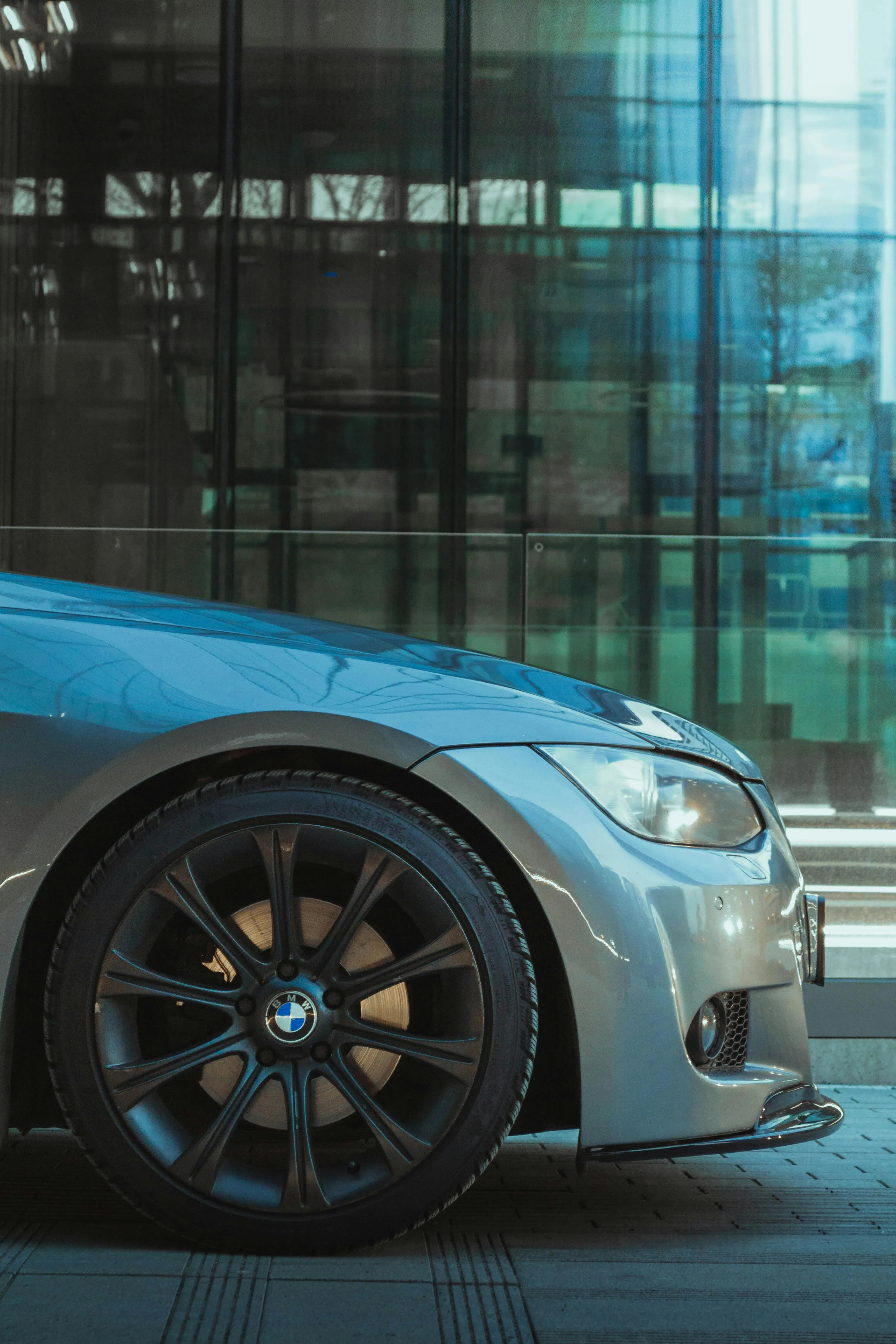 Side View of Blue Bmw in Modern Glass Building Area