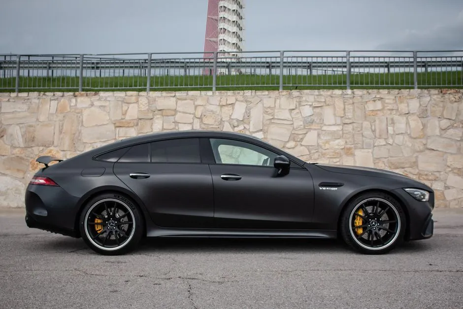 Side View of Mercedes AMG GT Coupe Near Stone Wall image