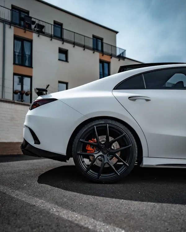 Side View of White AMG with Red Brake Calipers Wallpaper