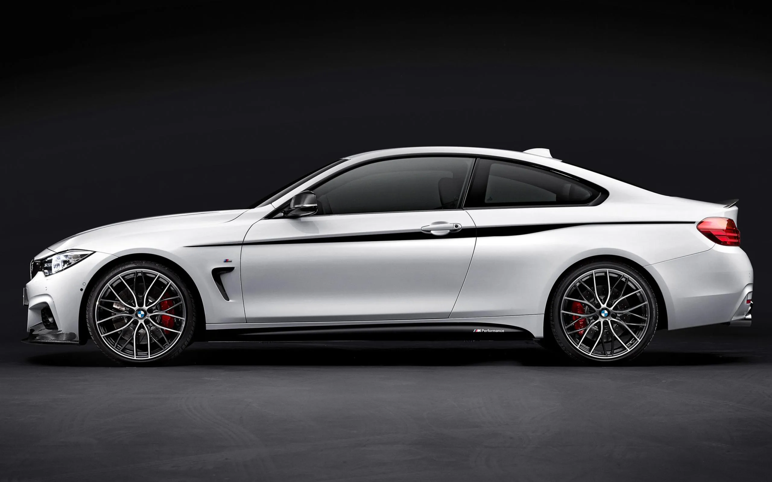 Side View of White Bmw Coupe in Dark Studio Lighting