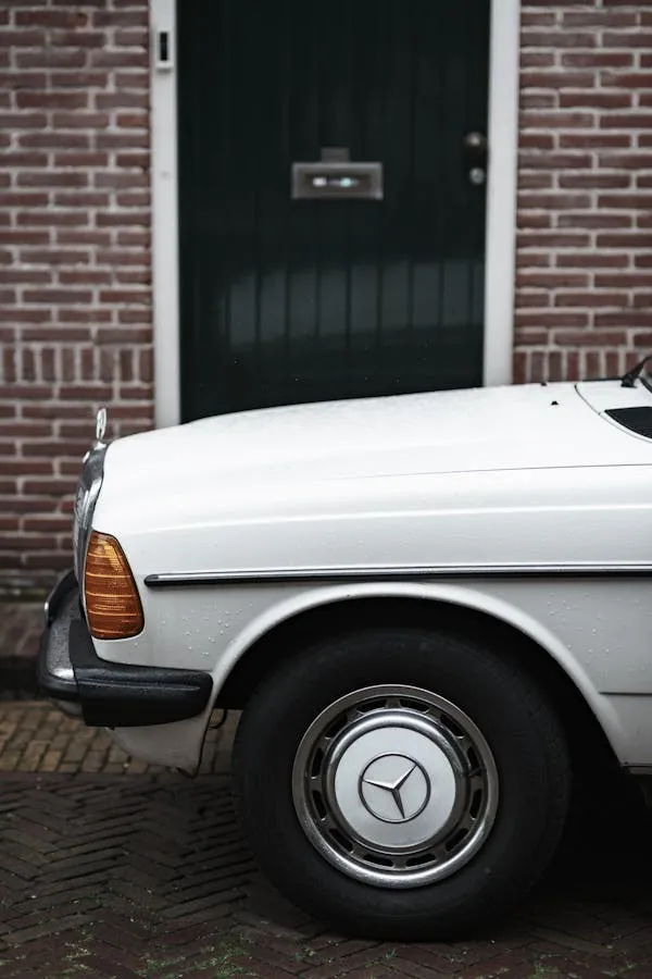 Side View of White Mercedes Benz Parked Near Black Door