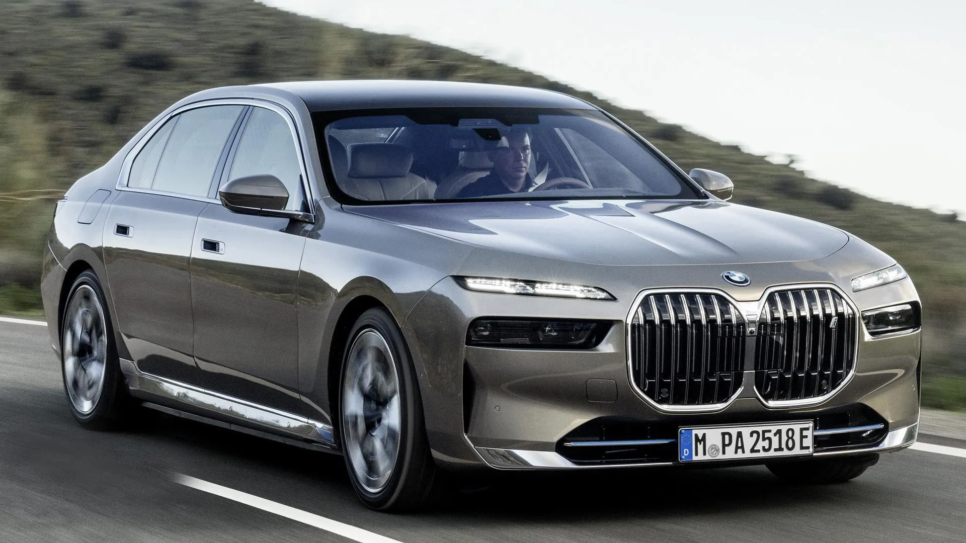 Silver Bmw 7 Series Luxury Sedan on Open Roadside Image