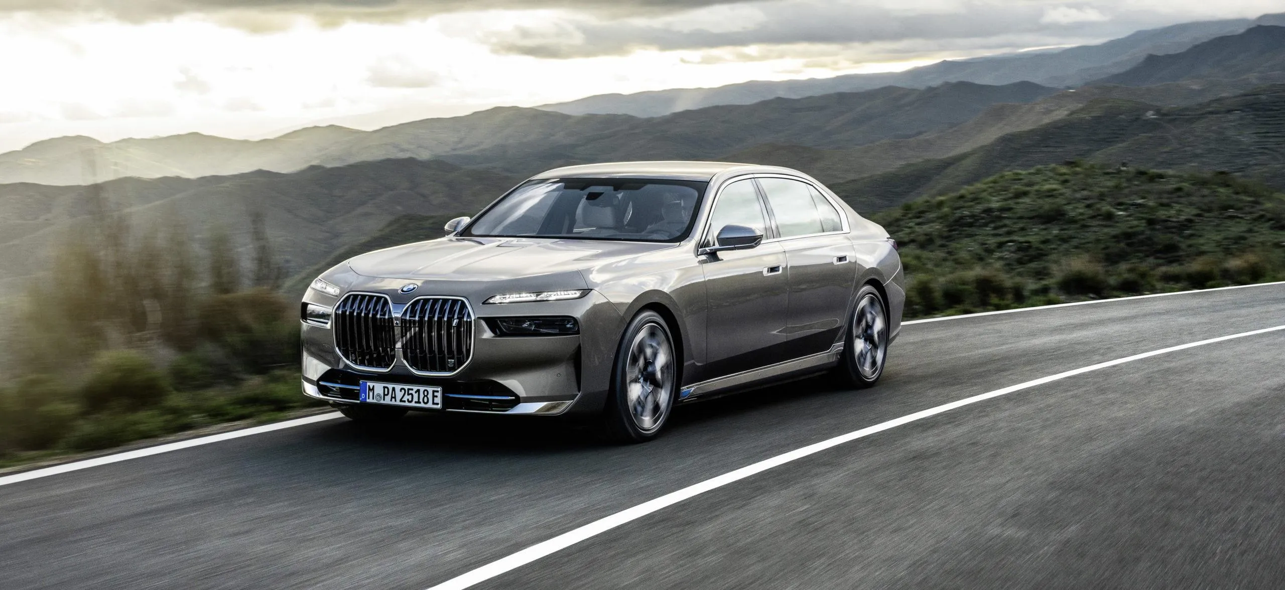 Silver Bmw Coupe Driving on Highway with Cloudy Sky