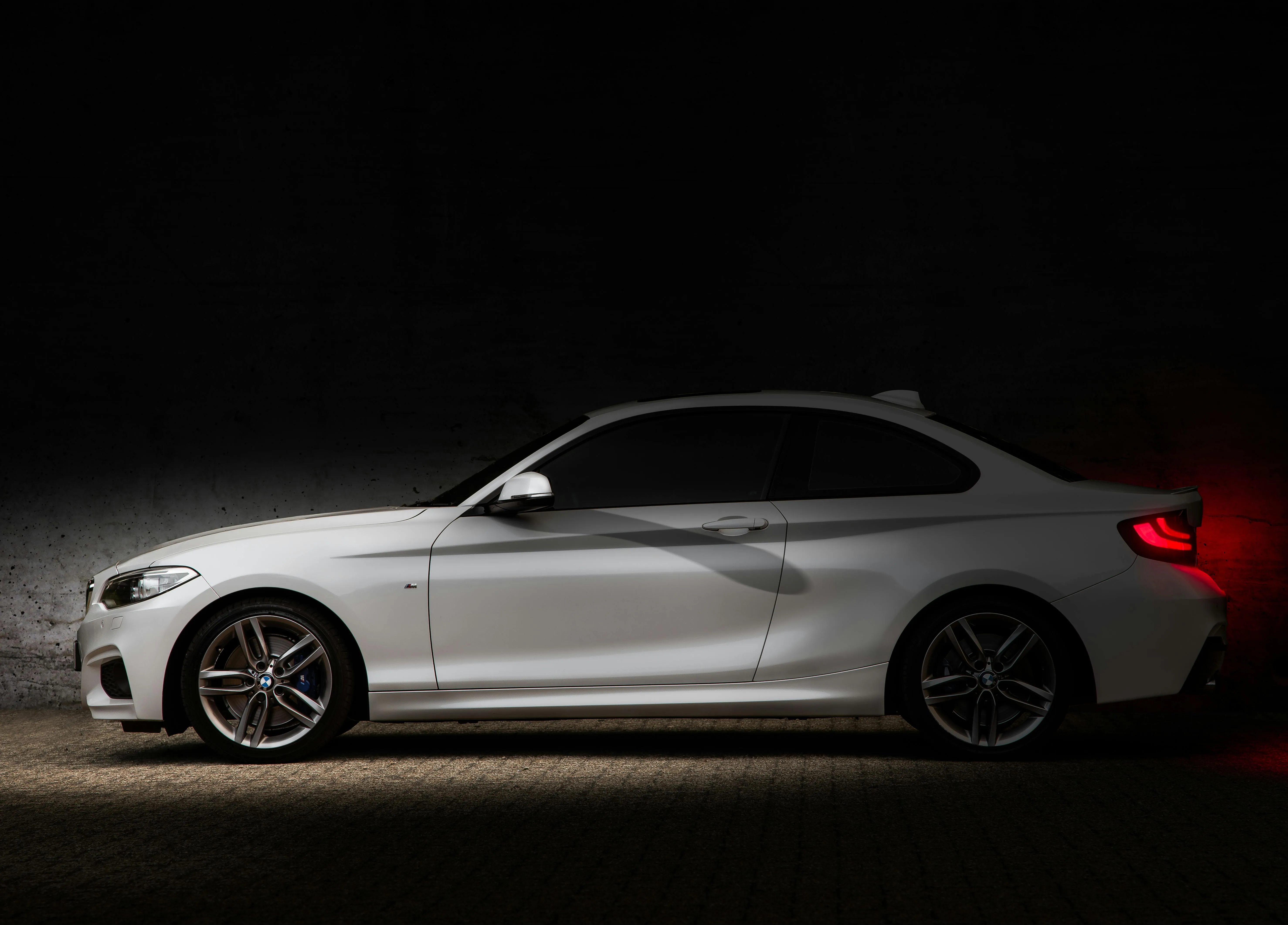 Silver Bmw Coupe Side View Against Dark Dramatic Background
