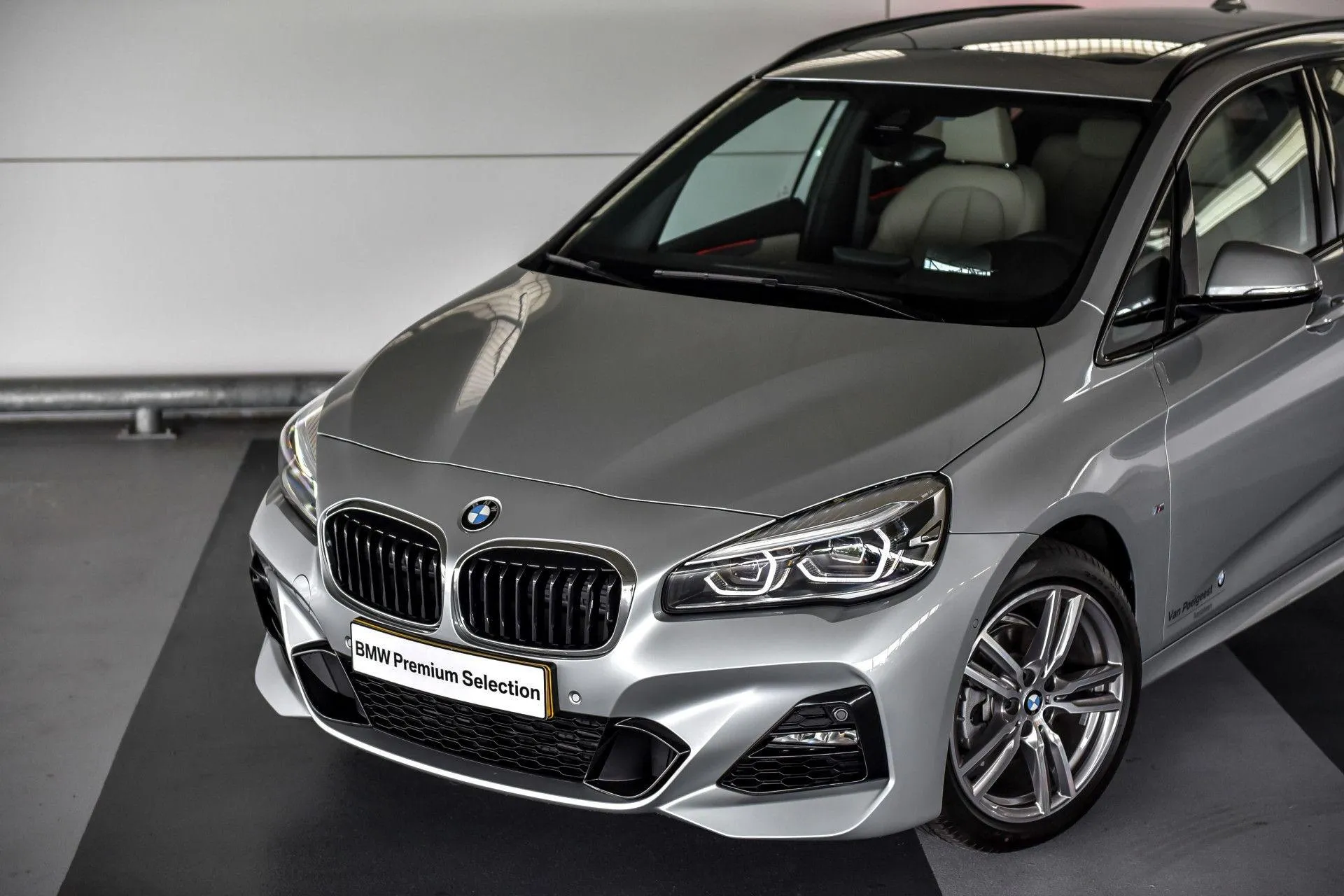 Silver Bmw Displayed Indoors with Clean Background