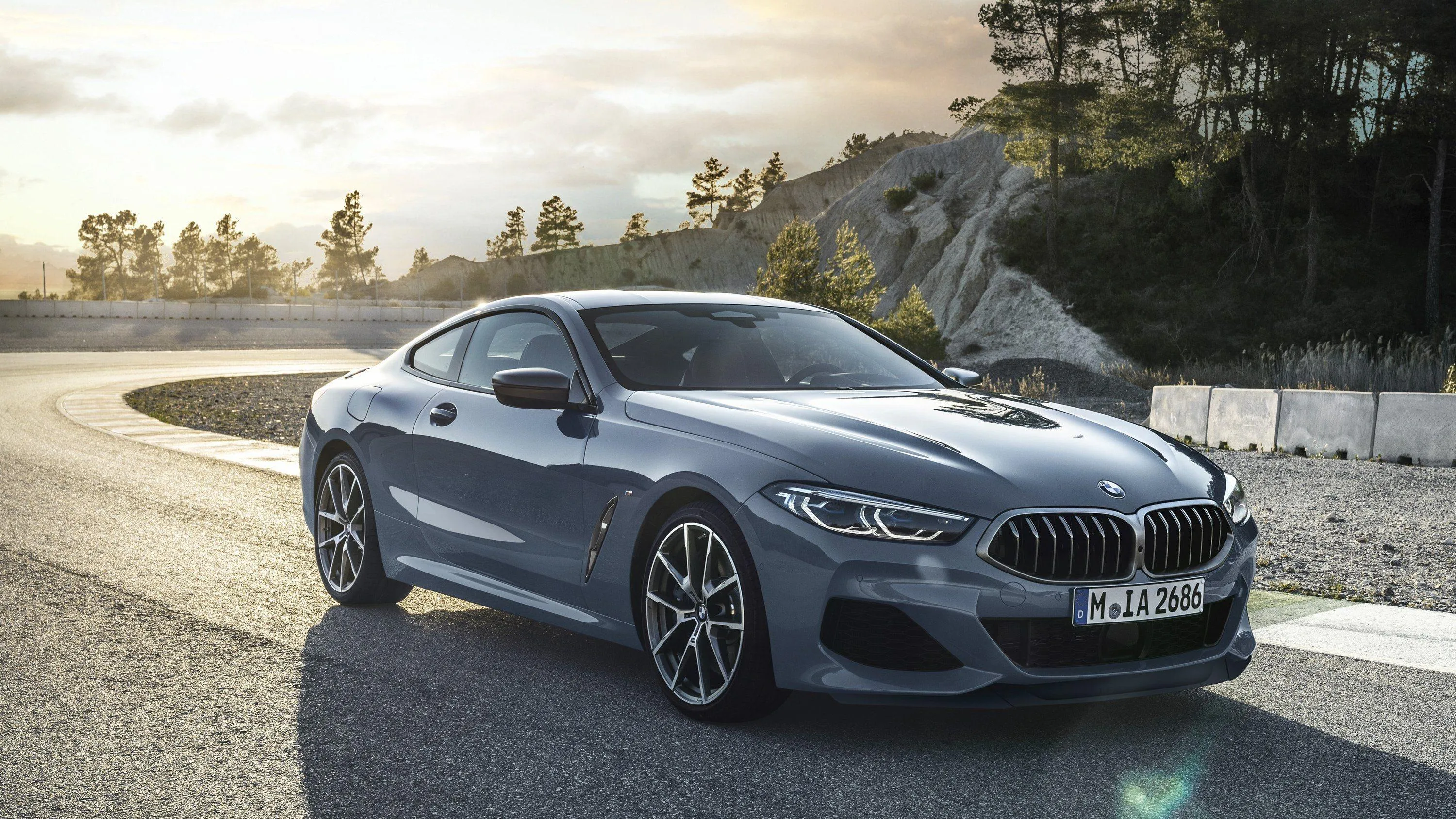 Silver Bmw Driving Beside Coast During Golden Sunset
