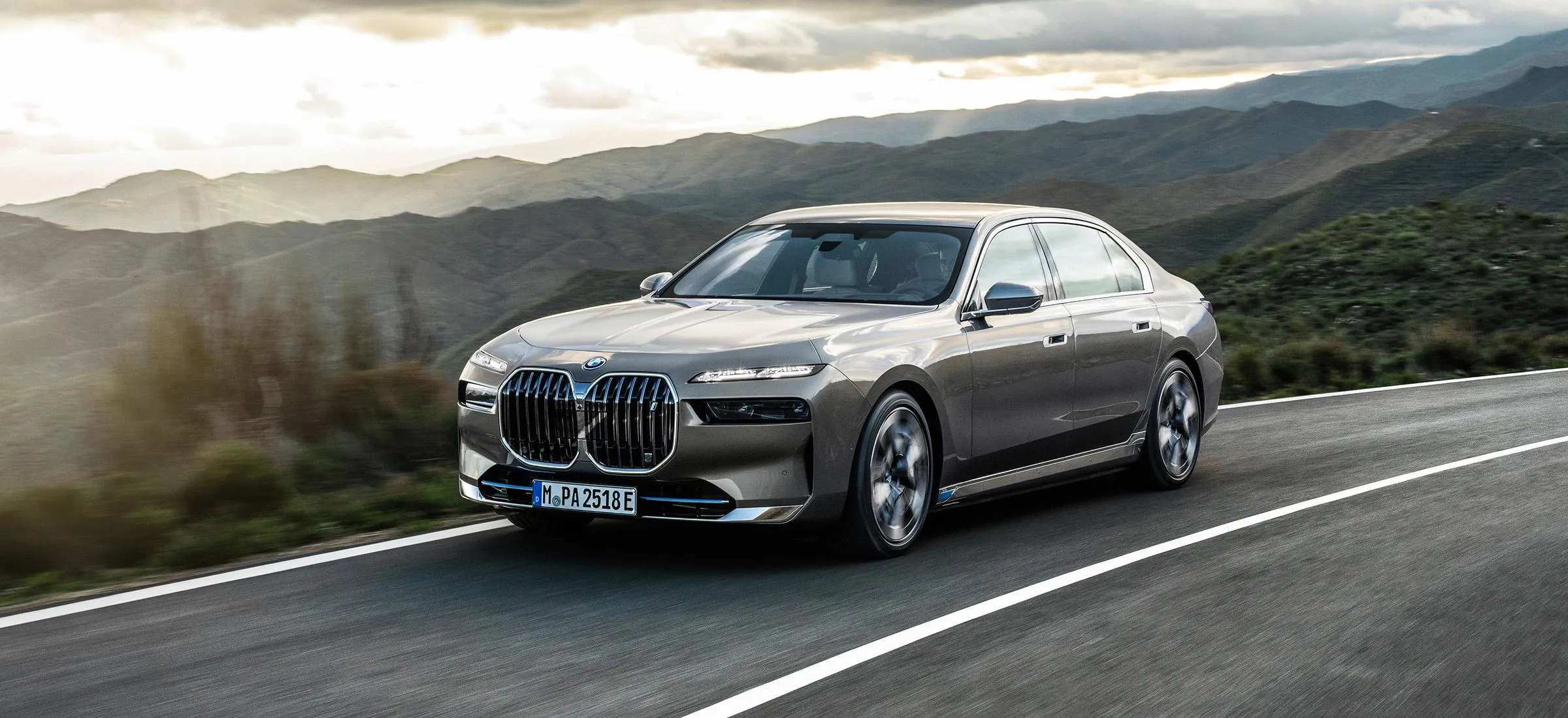 Silver Bmw Driving Fast on Scenic Countryside Road Image