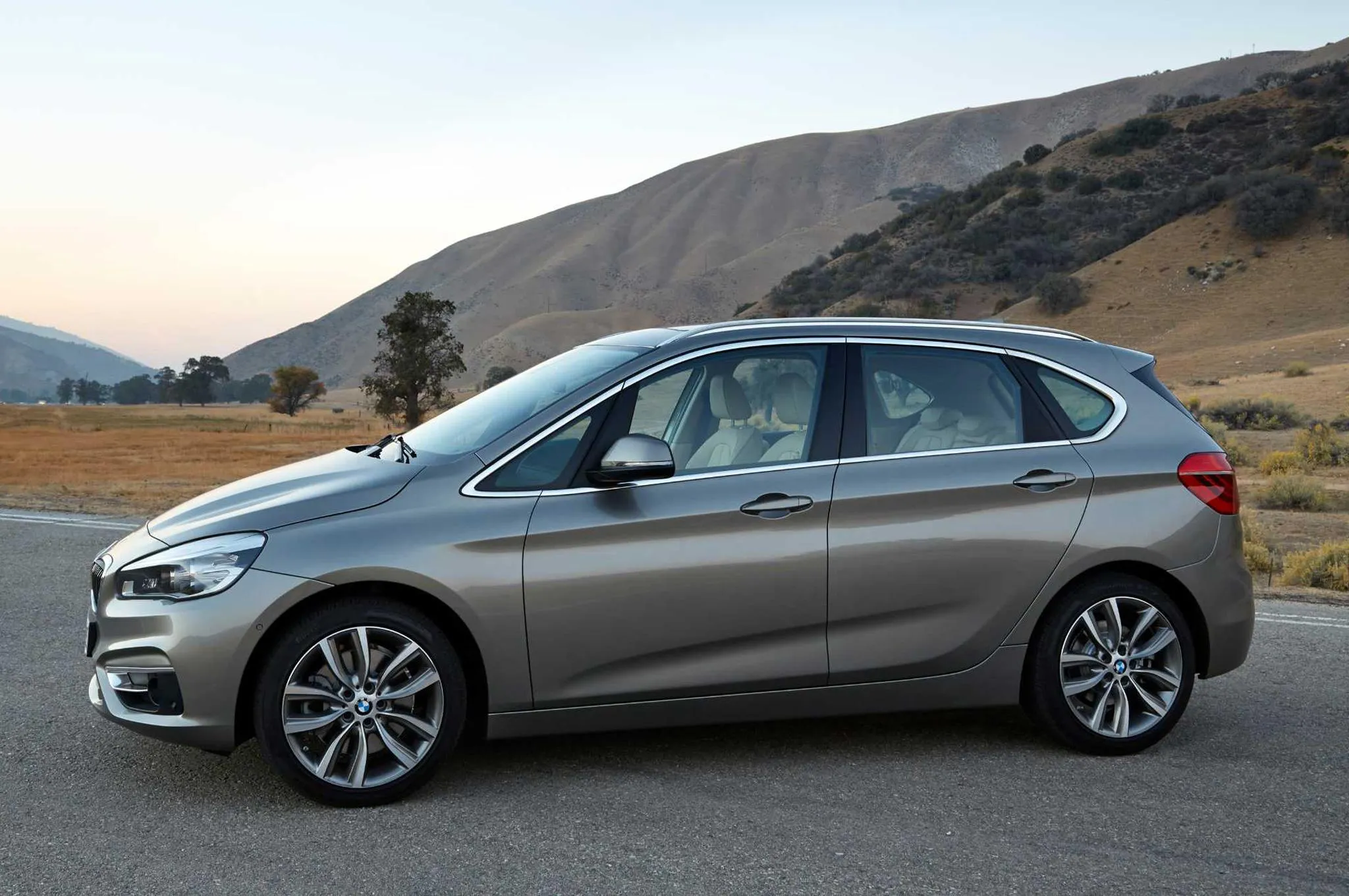 Silver Bmw Hatchback Parked on Hill Road in Daylight