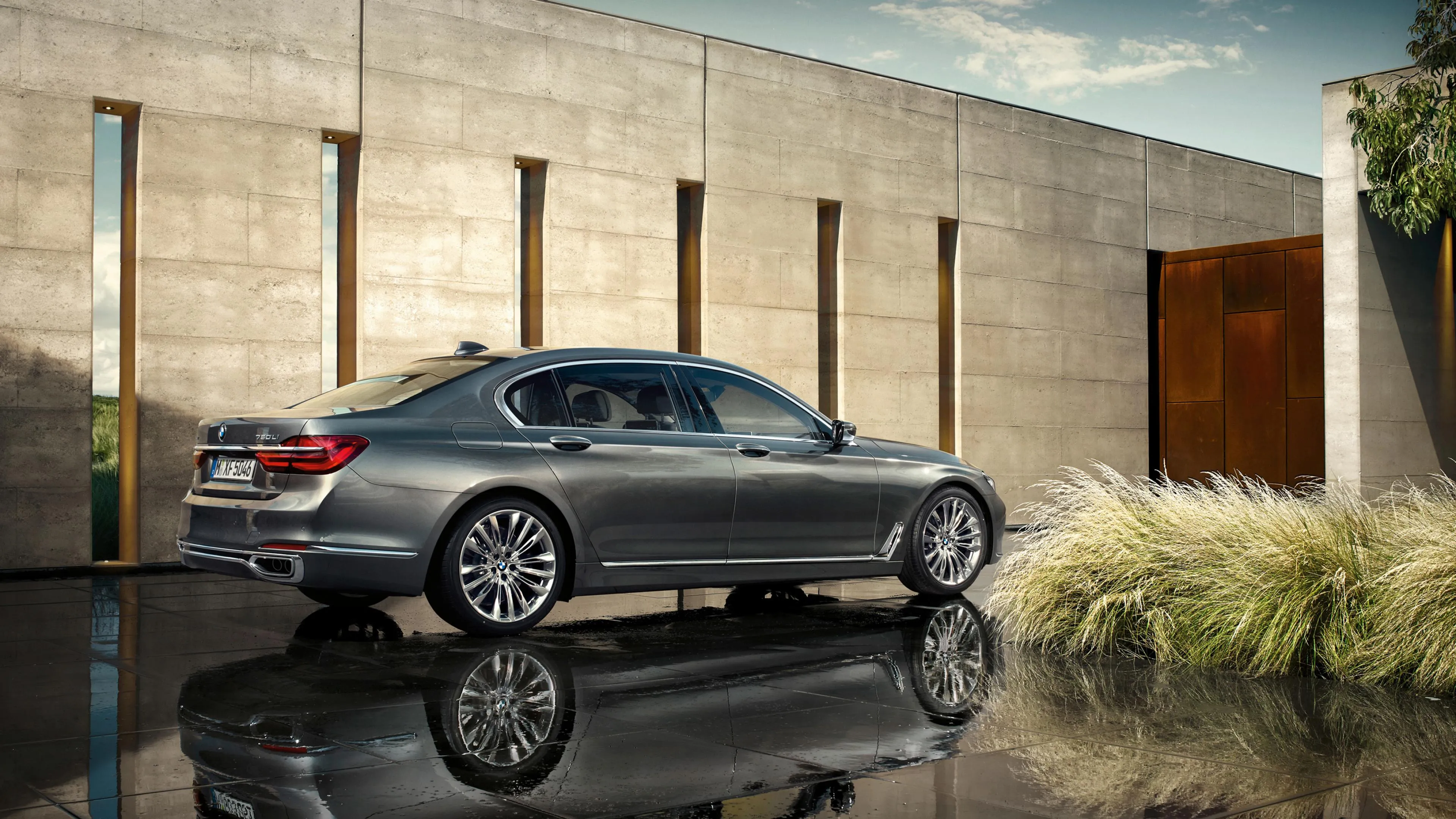 Silver Bmw Parked Beside Modern House with Clear Skies