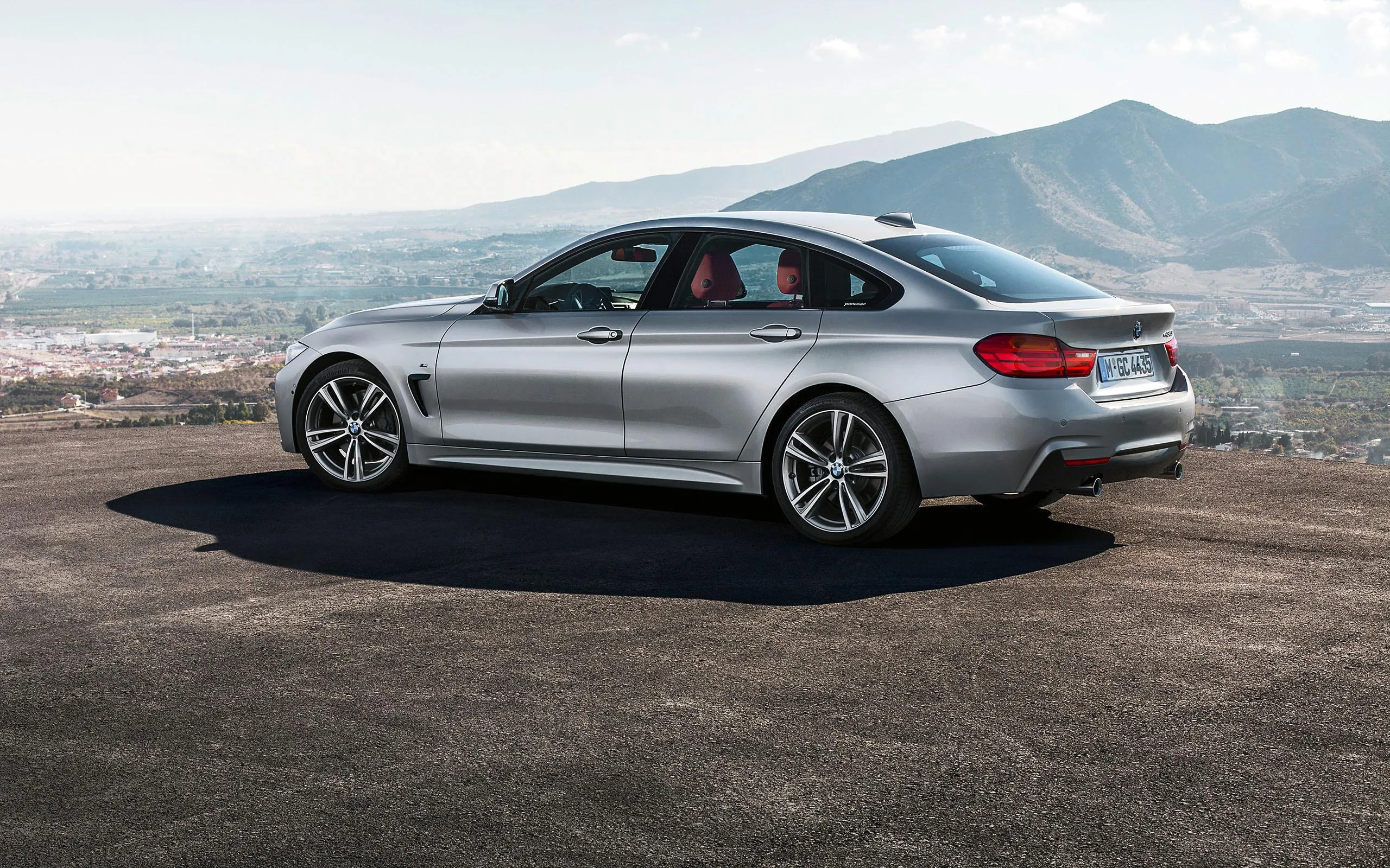 Silver Bmw Parked on High Cliff Road with Mountains View