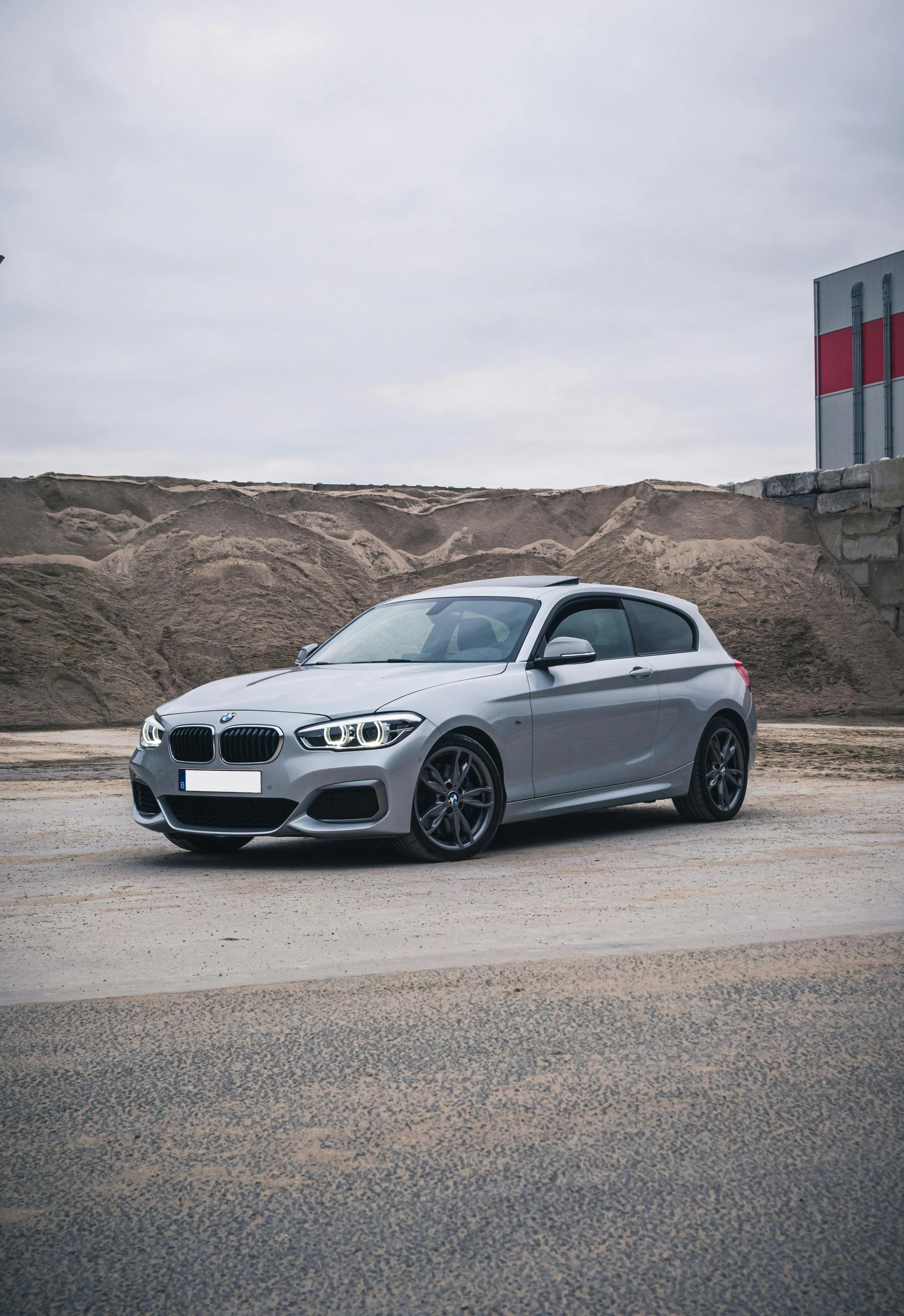 Silver Bmw Parked on Road with Construction in Background