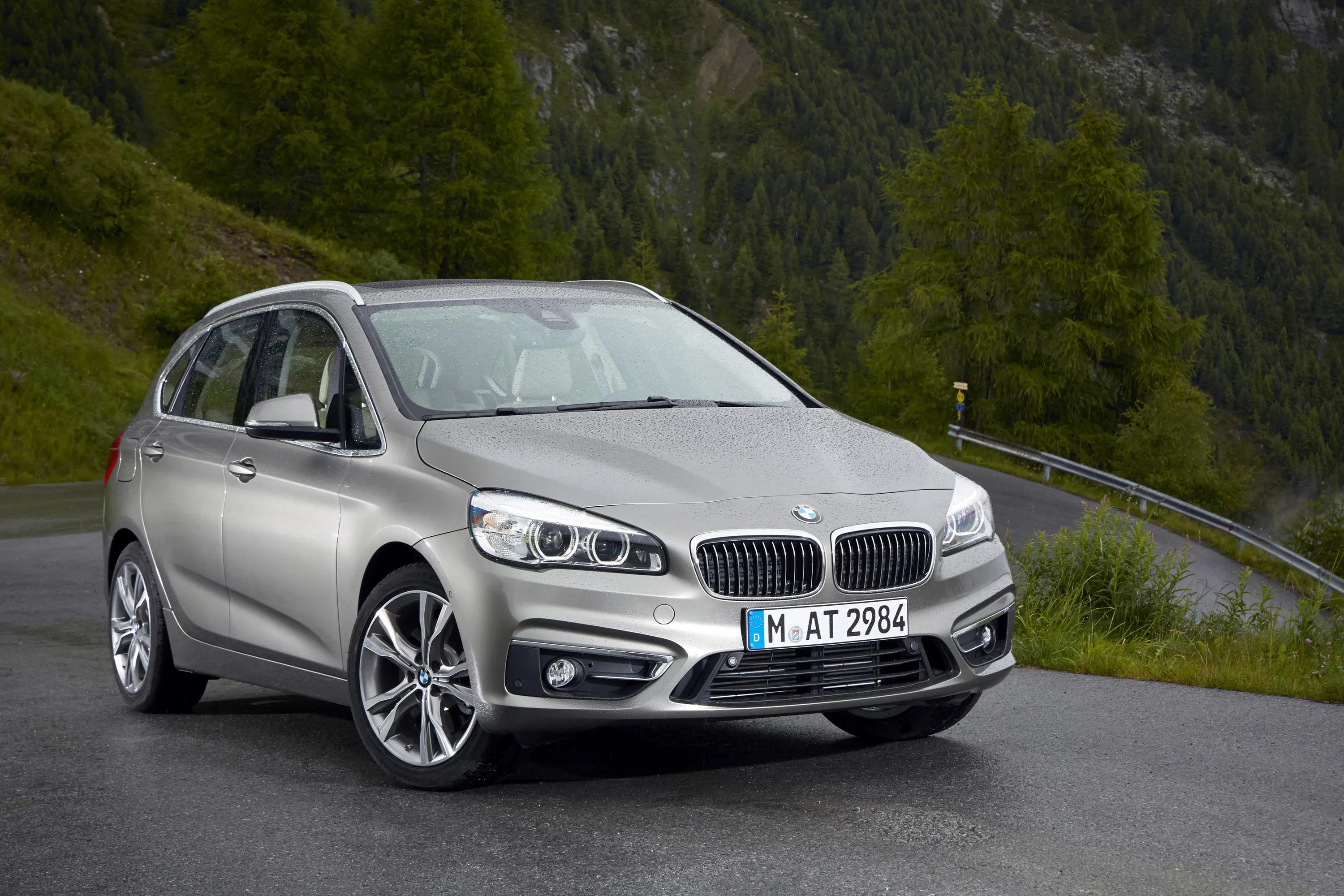 Silver Bmw Parked on Roadside in a Quiet Urban Setting