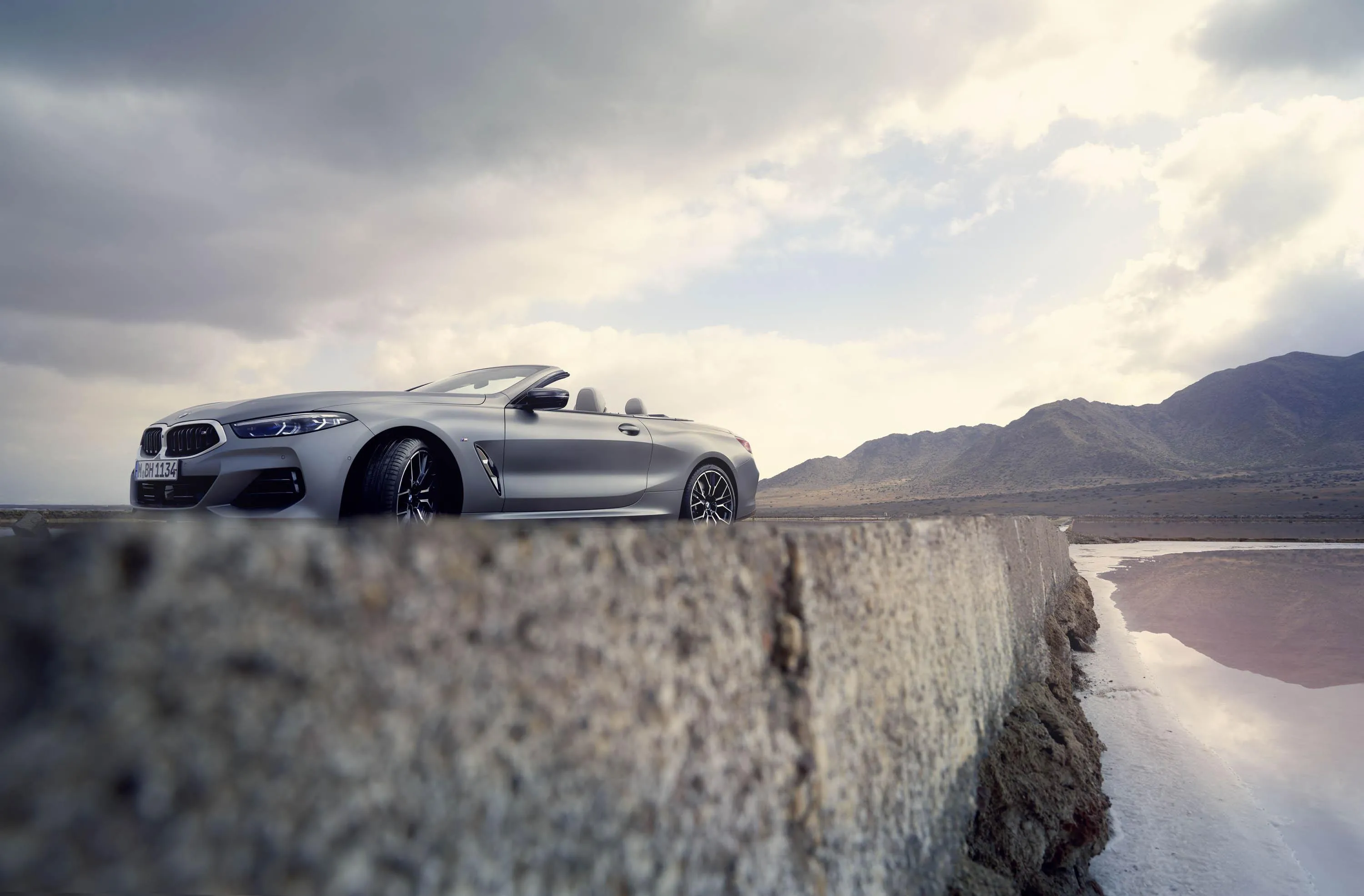 Silver Bmw Sedan Driving Along Coastal Cliff Highway