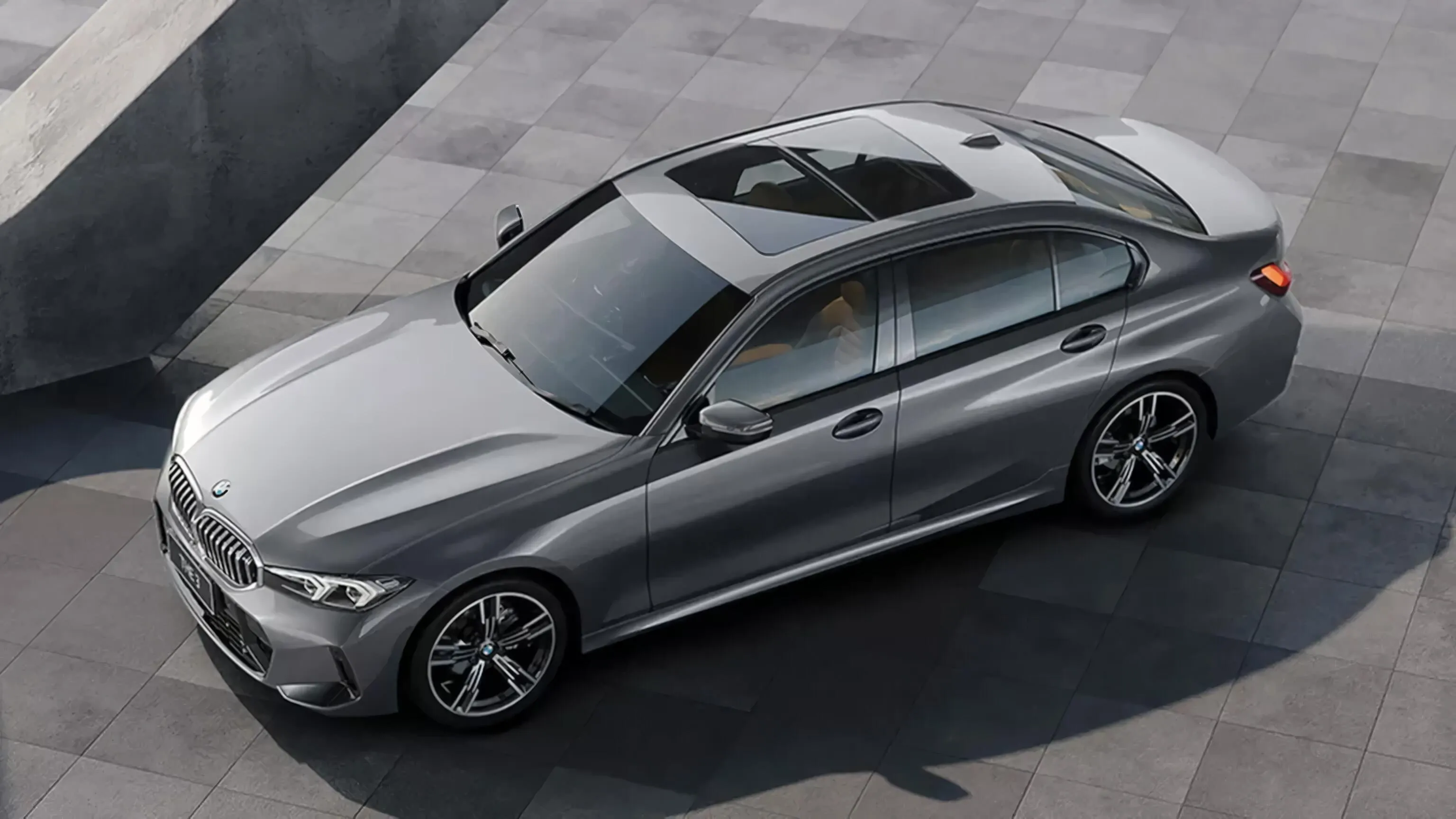 Silver Bmw Sedan Parked in a Modern Concrete Driveway