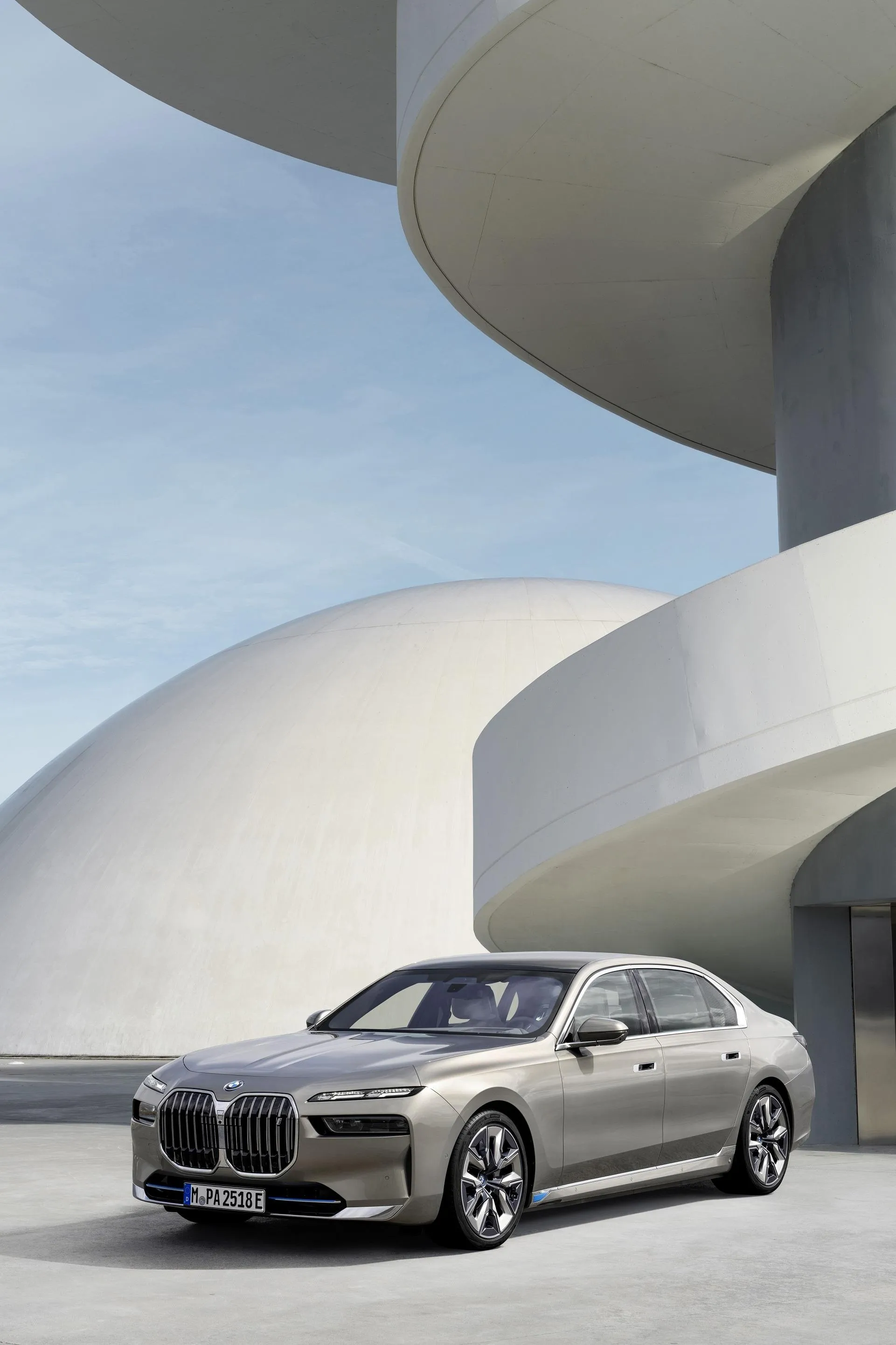 Silver Bmw Sedan Posed Near Spiral Modern Architecture