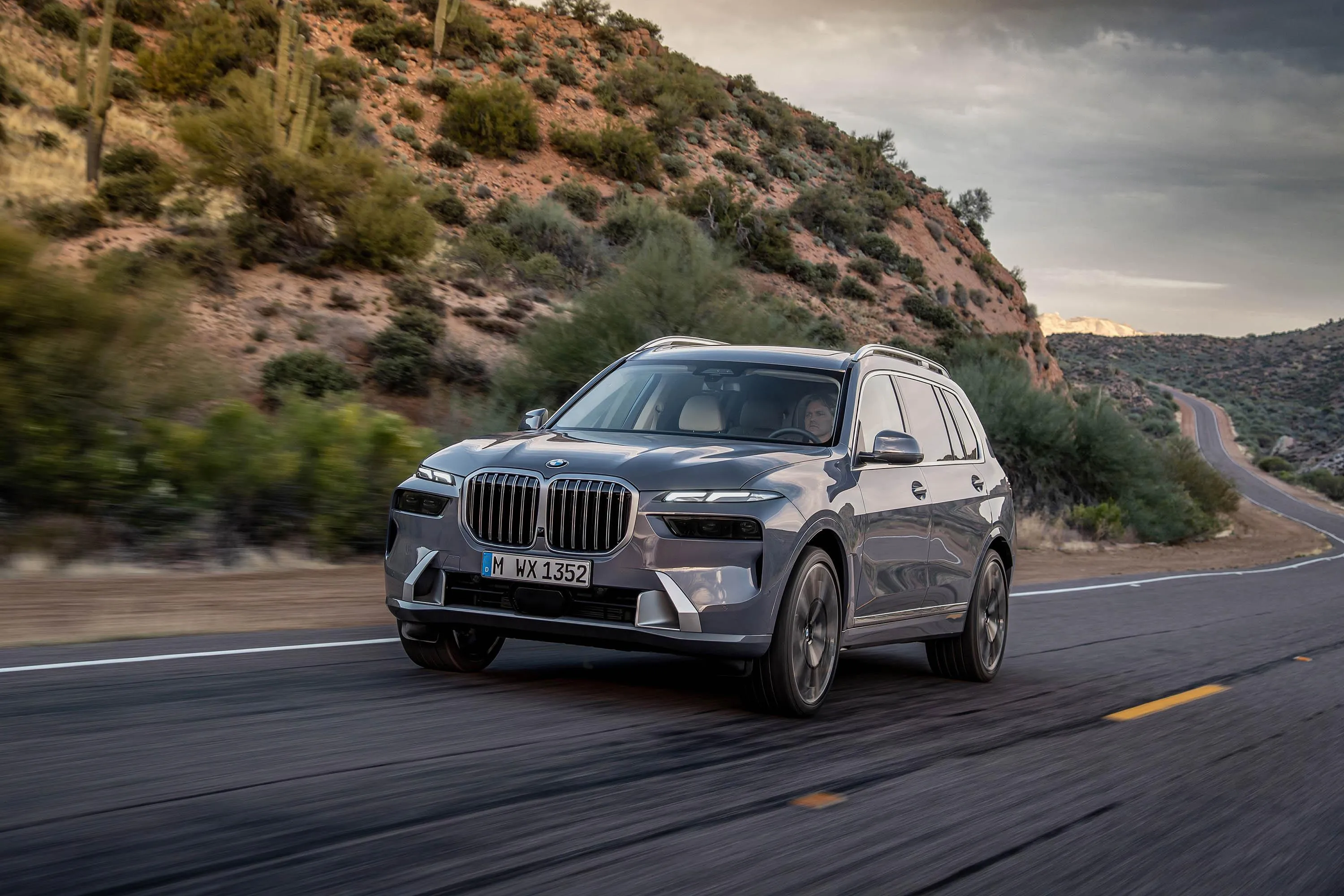 Silver Bmw Suv Driving on Coastal Road with Mountain Image