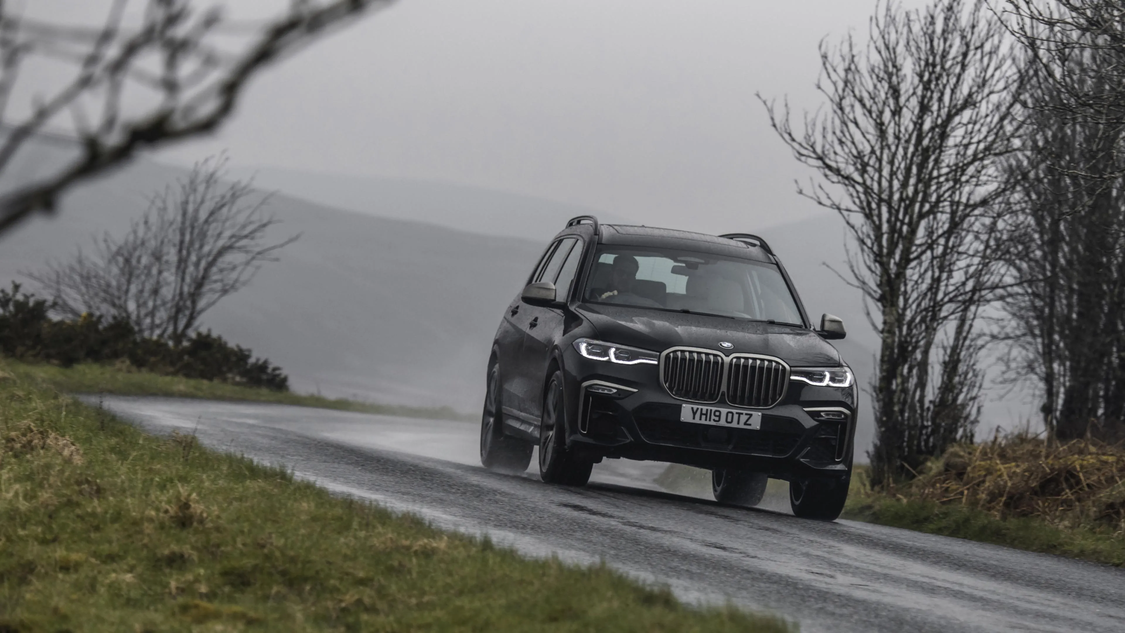 Silver Bmw Suv Driving Through Winter Trees with Fog