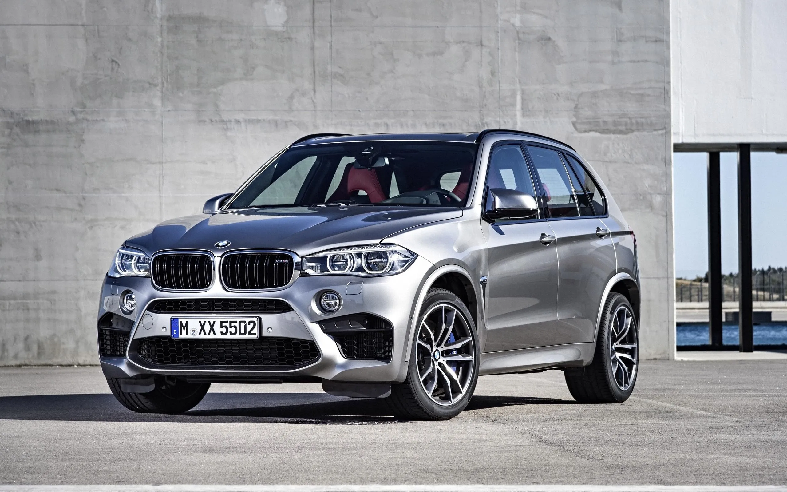 Silver Bmw Suv Parked Near Concrete Wall on Sunny Day