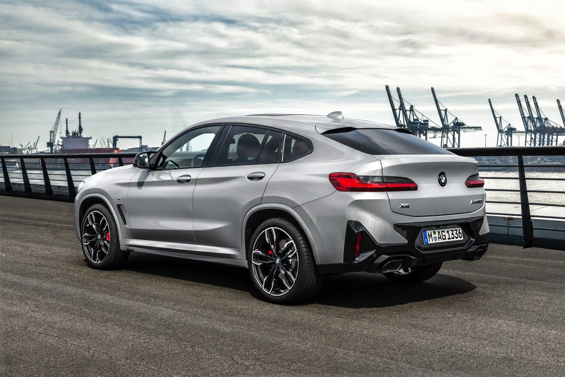 Silver Bmw Suv Parked Near Industrial Shipyard Docks